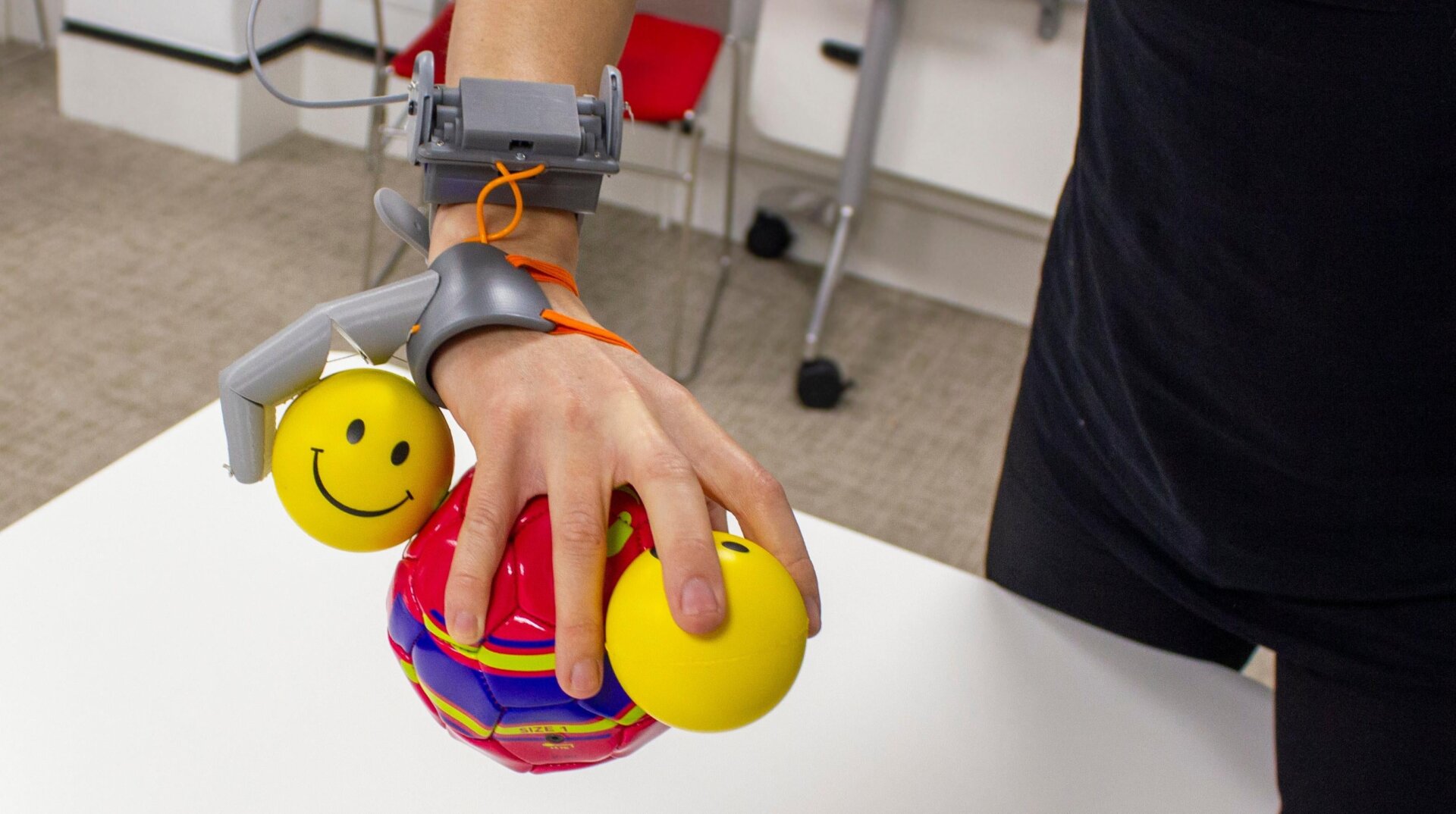 The Third Thumb being used to hold multiple balls. 