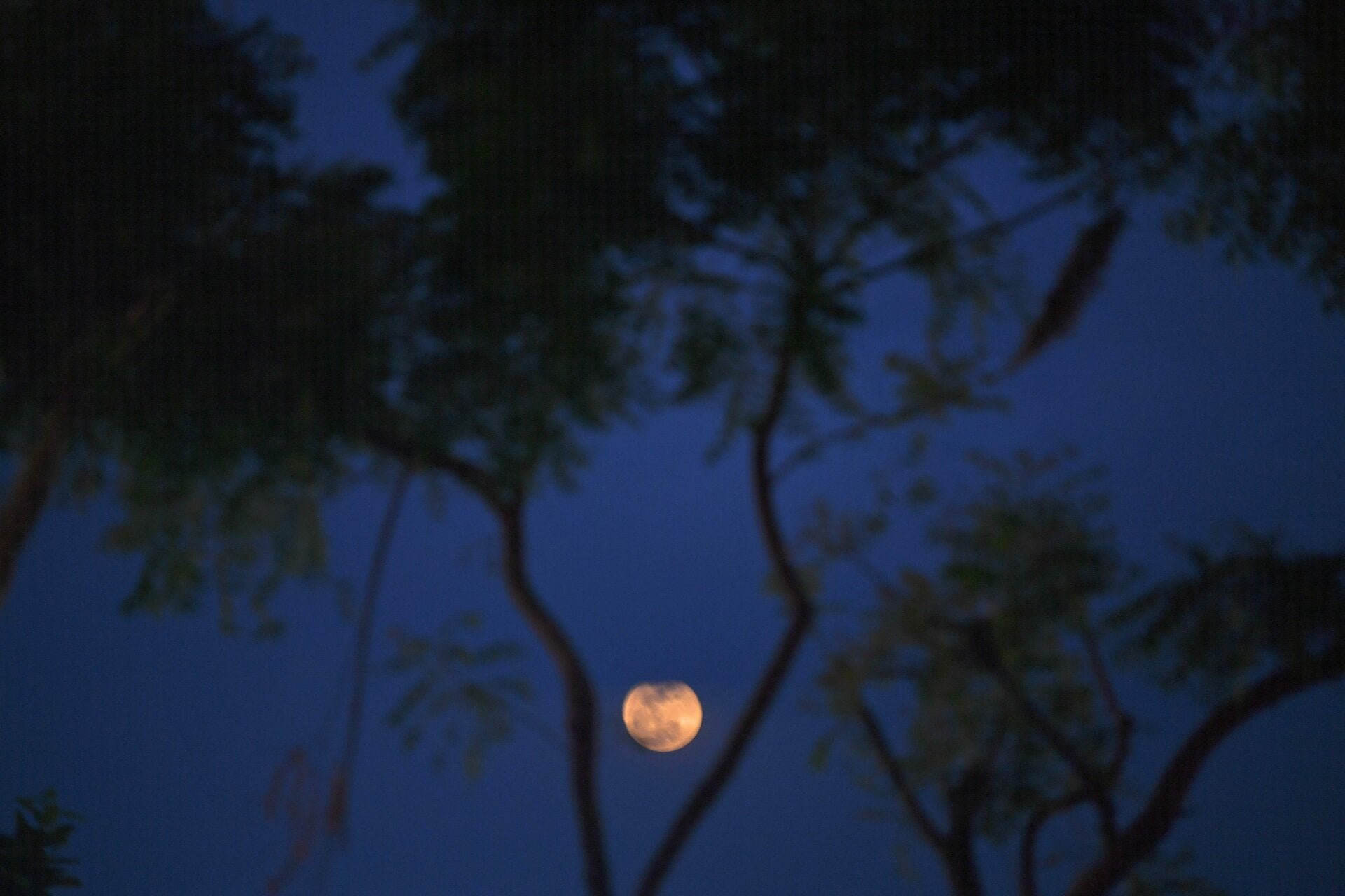 The moon is pictured over the skies of Mumbai on May 26, 2021 during a total lunar eclipse.