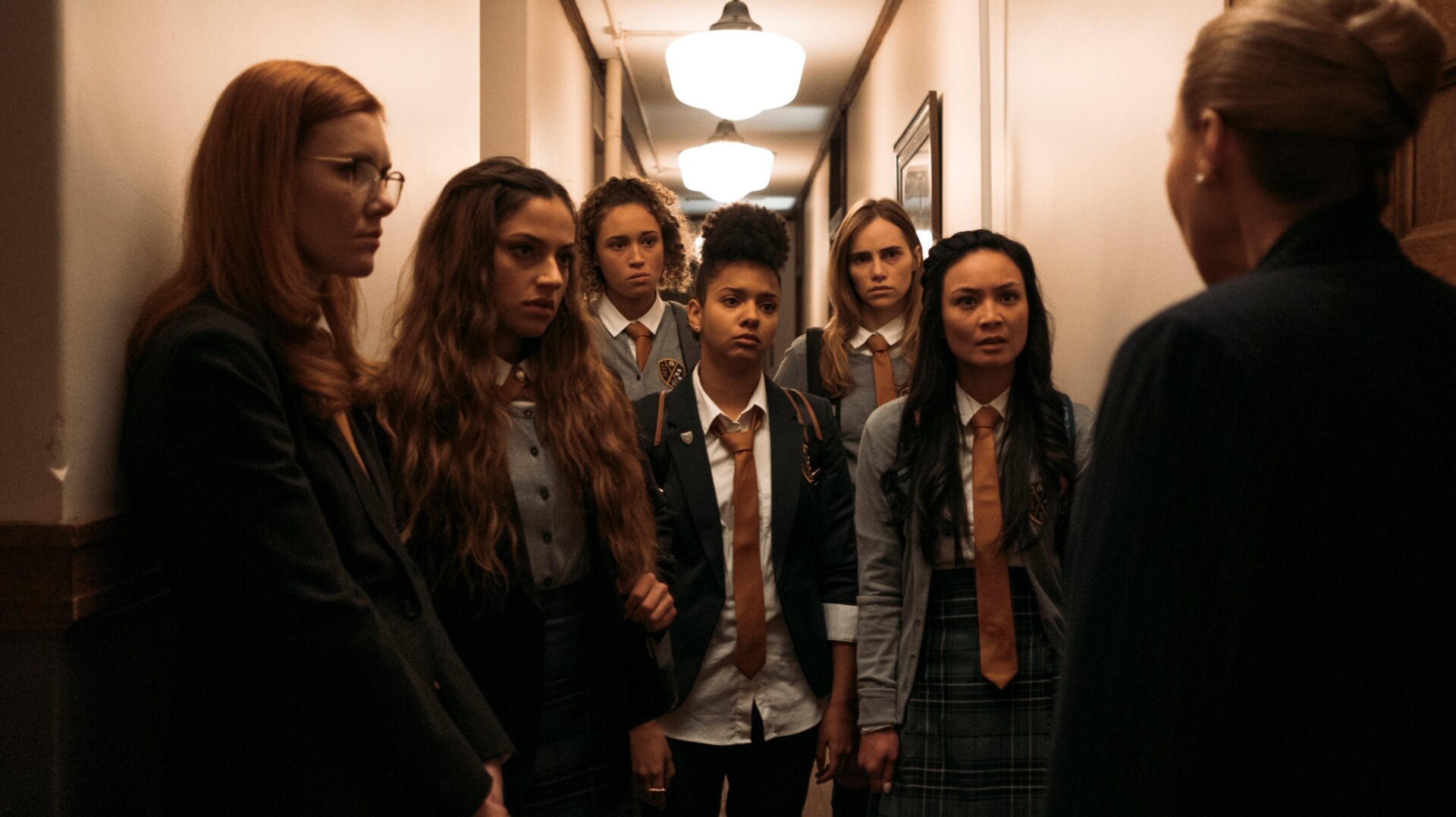 The Seance girls, looking grim.