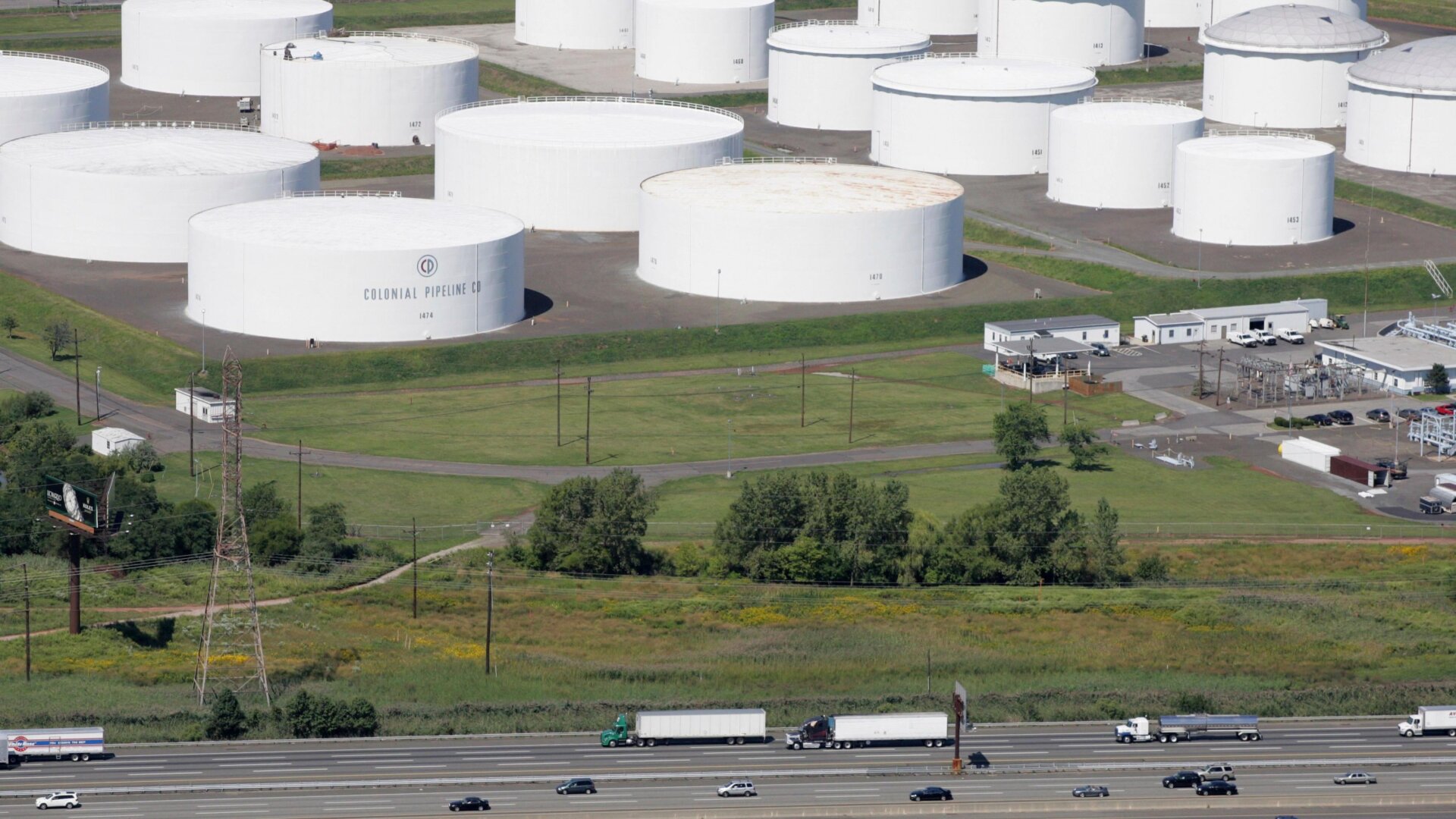 Traffic on I-95 passes oil storage tanks owned by the Colonial Pipeline Company in Linden, N.J.