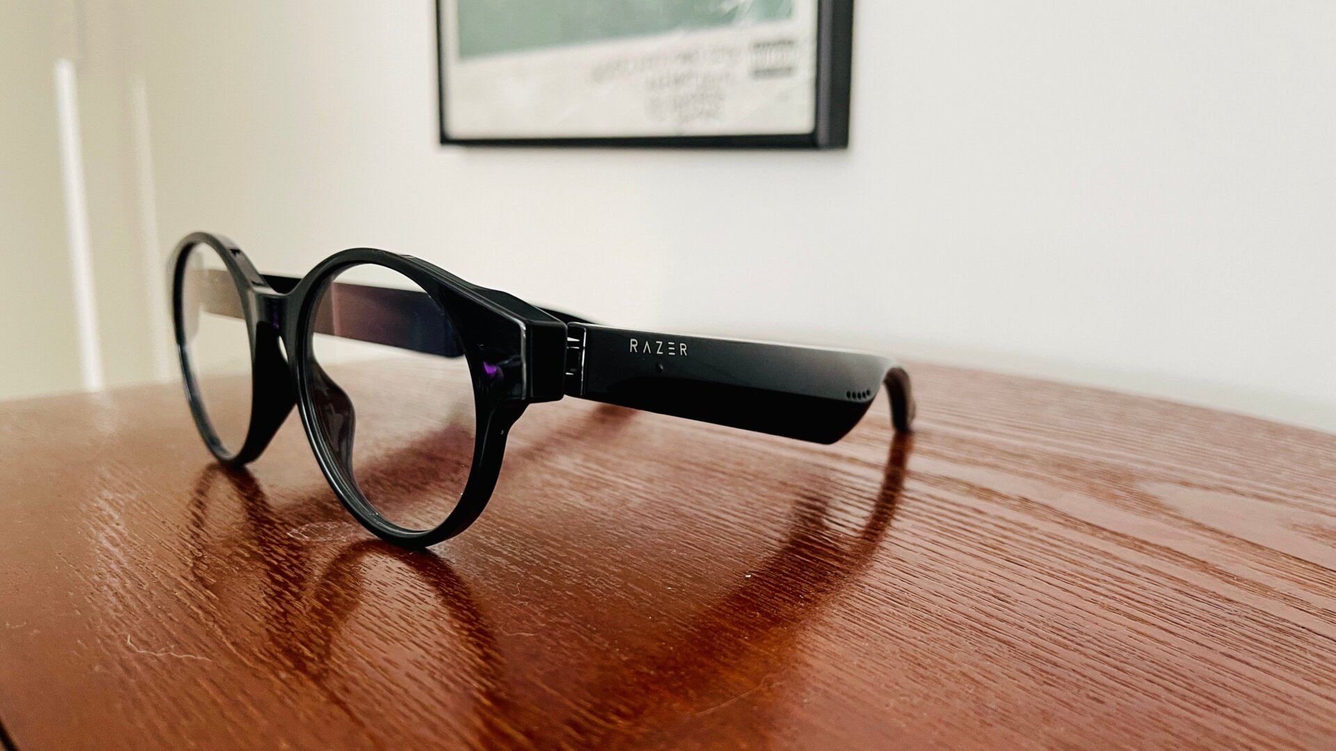 Thick arms! The touch control area is right by the Razer logo.