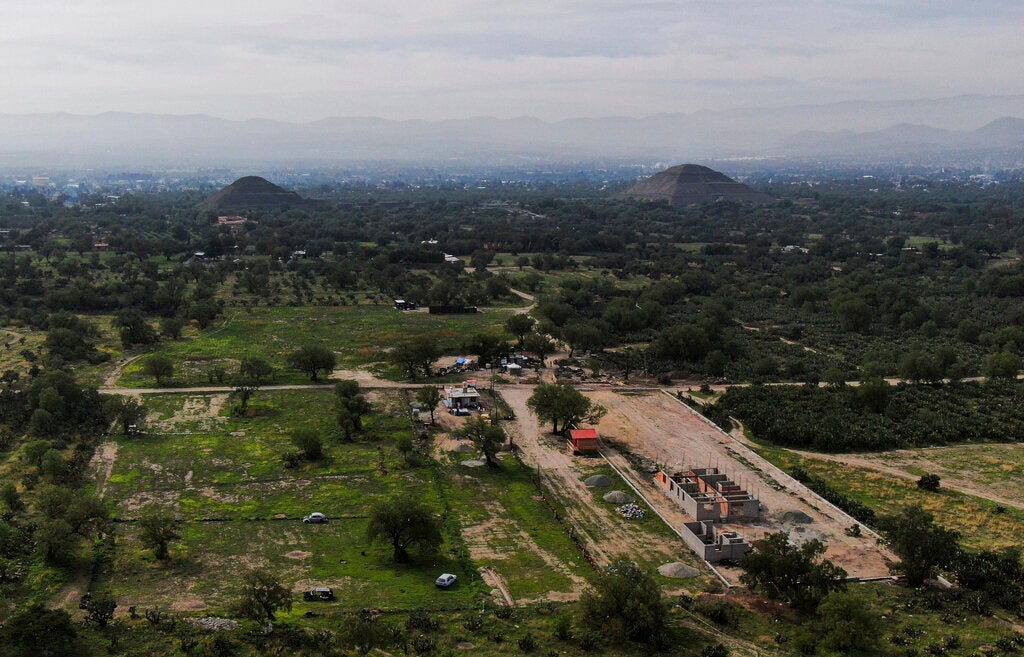 The construction site, shown in context with Teotihuacan in the background. Upwards of 25 unexplored structures are believed to exist on this protected land. 