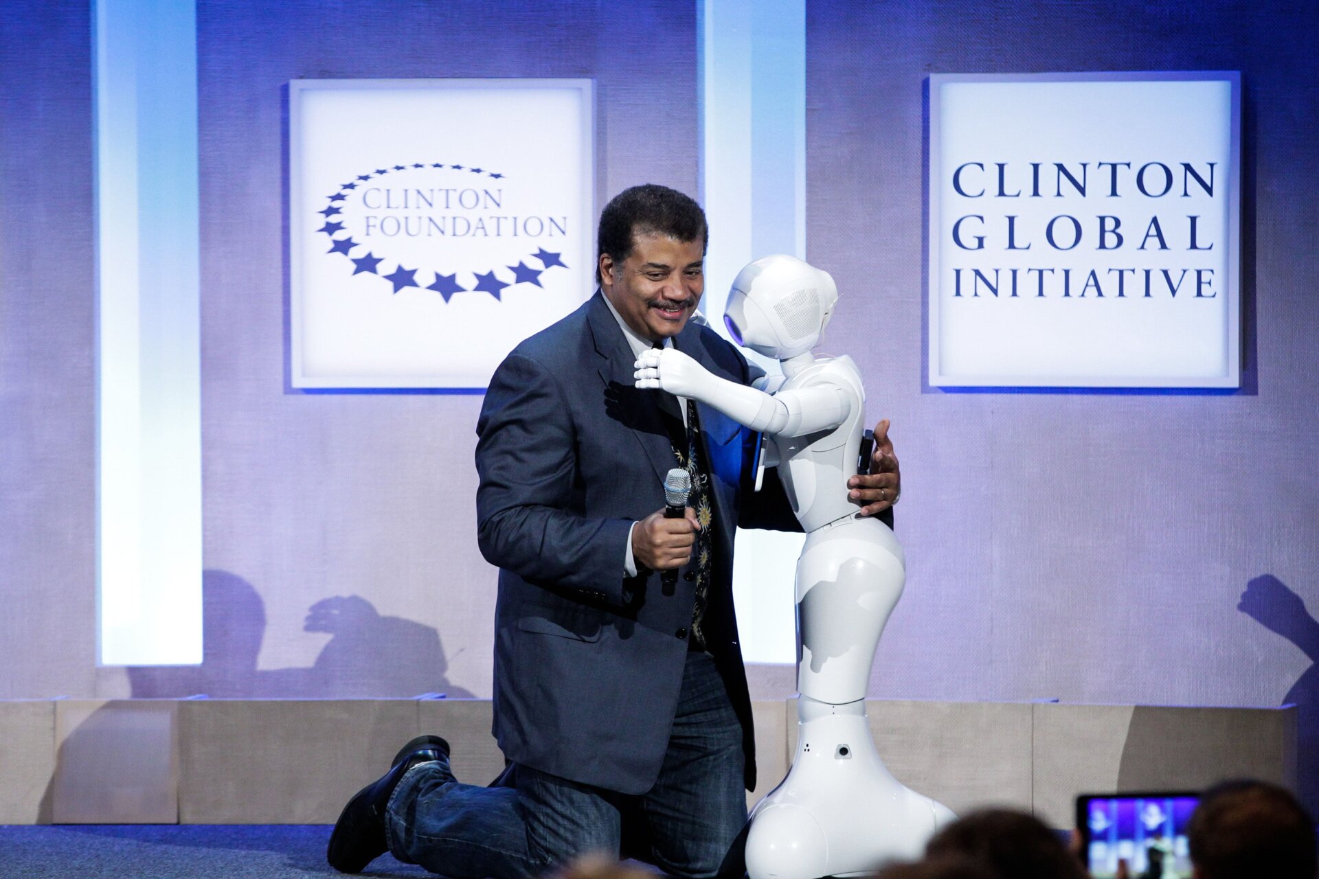 Neil deGrasse Tyson hugs Pepper at the Looking to the Next Frontier session during the 2015 Clinton Global Initiative’s Annual Meeting at the Sheraton New York Hotel & Towers on September 28, 2015 in New York City.