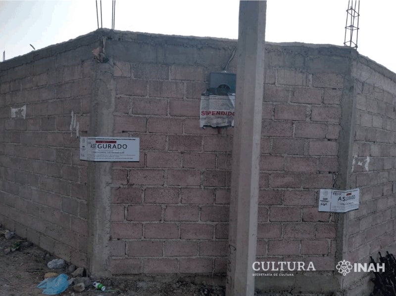 Walls of the construction site, with ministry labels now declaring the area secured.