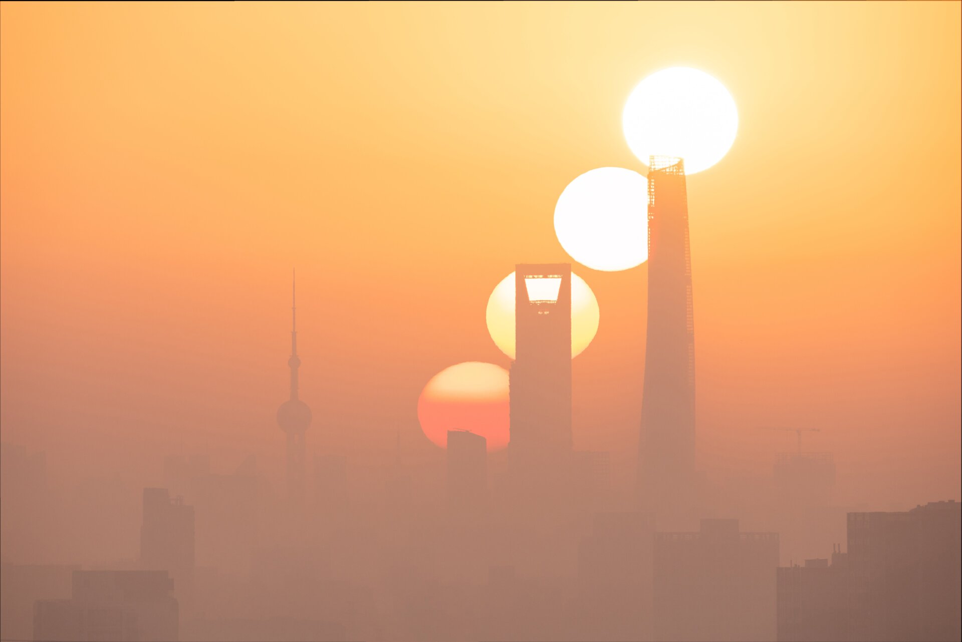 Four different exposures showing a sunrise over Shanghai. 