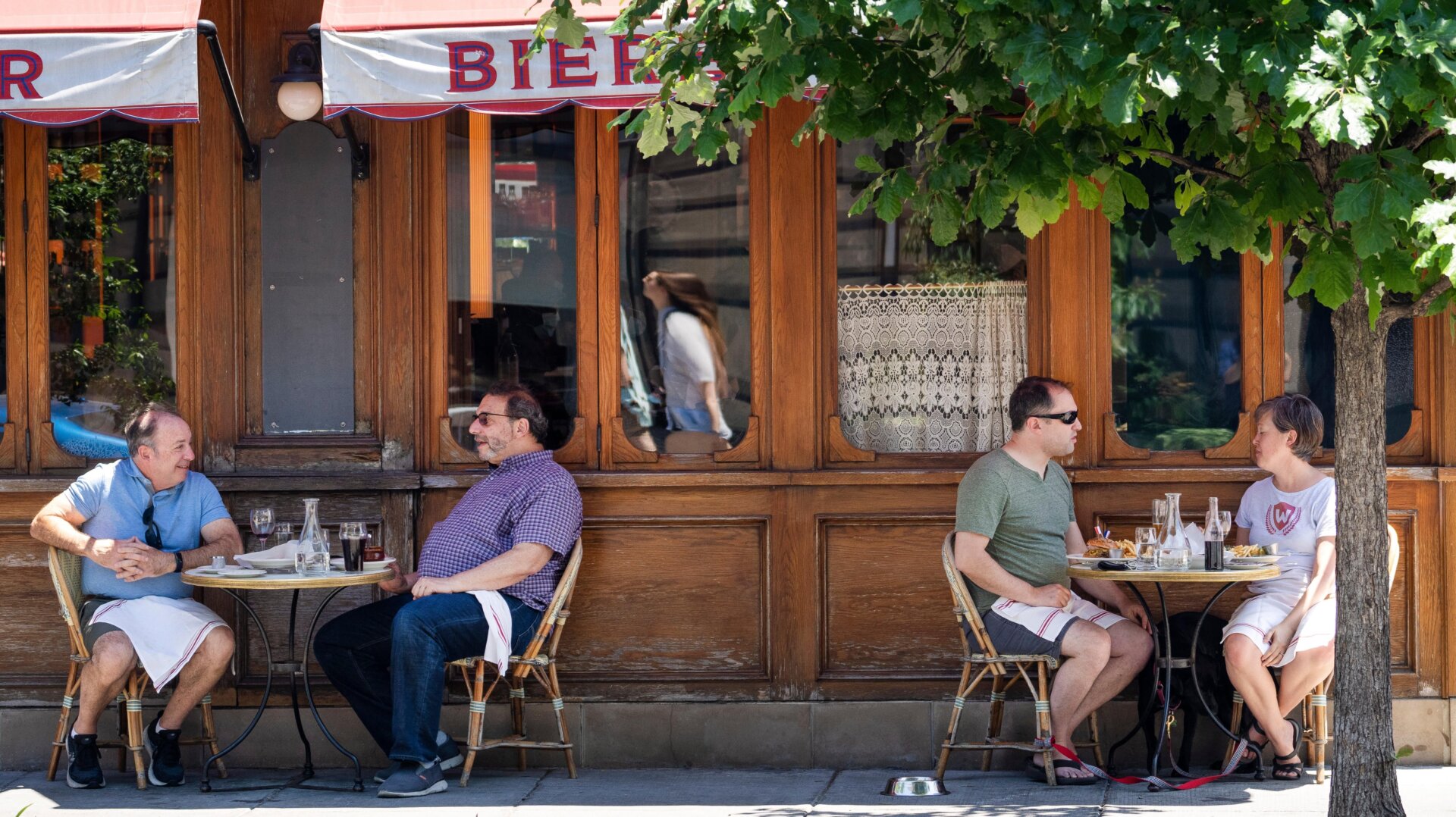 People eat outside during the lunch hour at a restaurant on 14th Street NW in Washington, D.C.