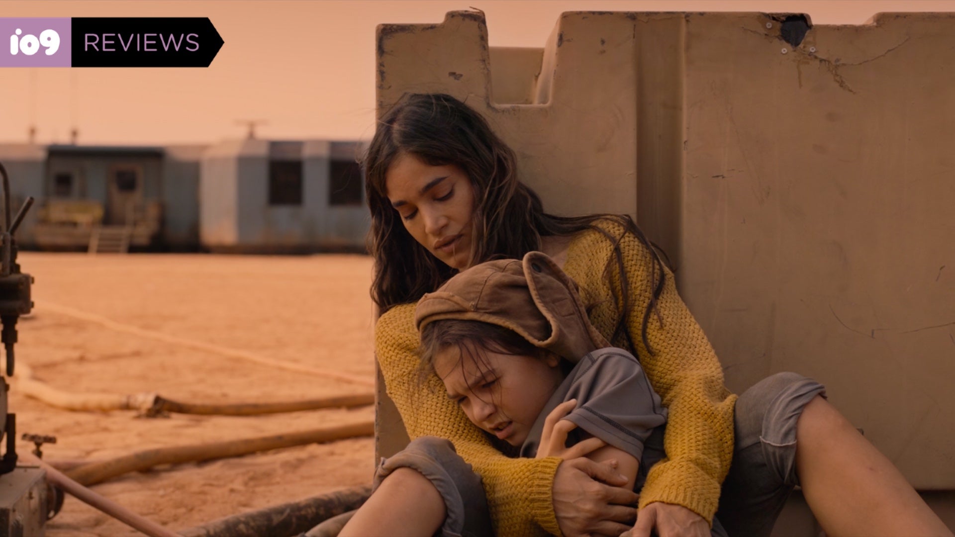 Ilsa (Sofia Boutella) holds a distraught Remmy (Brooklynn Prince).