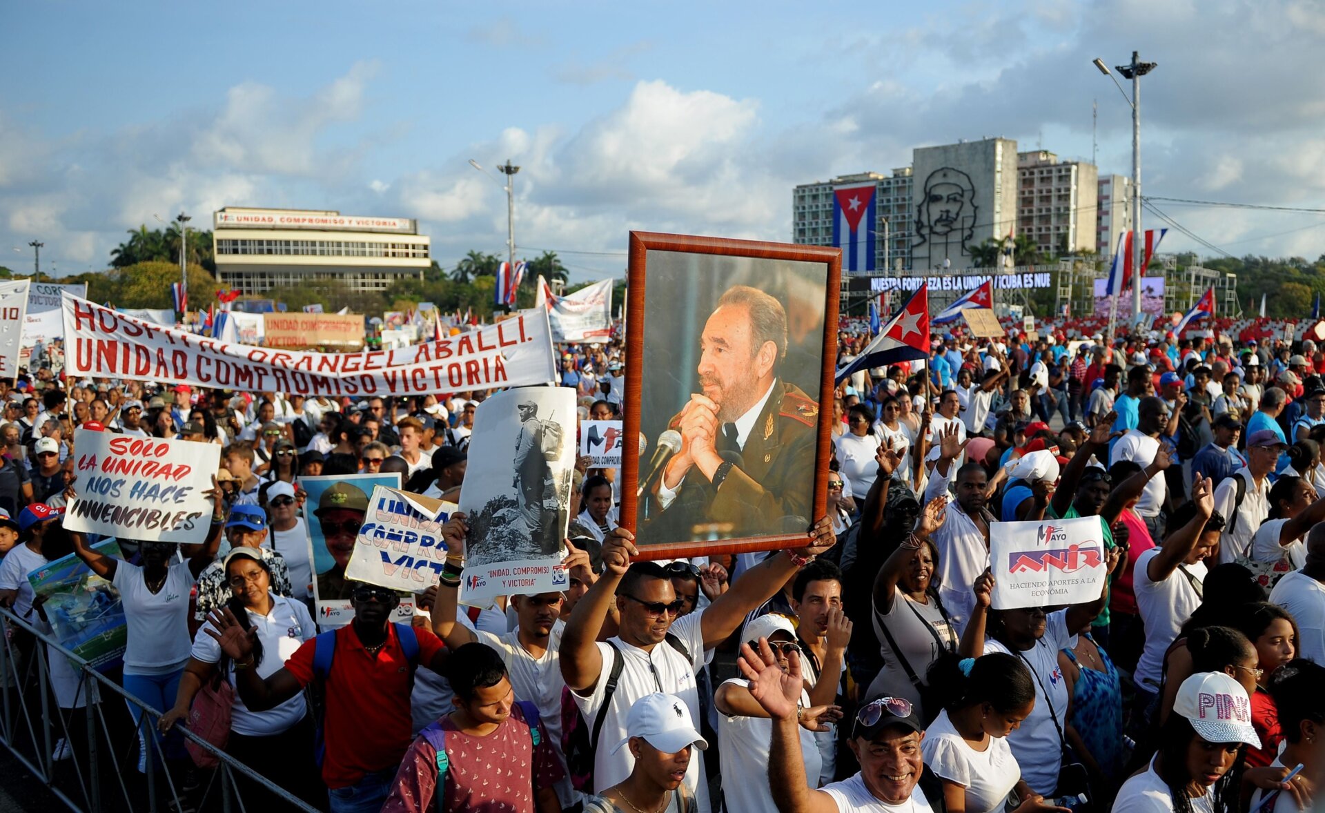 A poster with an image of late Cuban leader Fidel Castro is seen amid the crowd during the May Day rally at Revolution Square in Havana on May 1, 2018. 