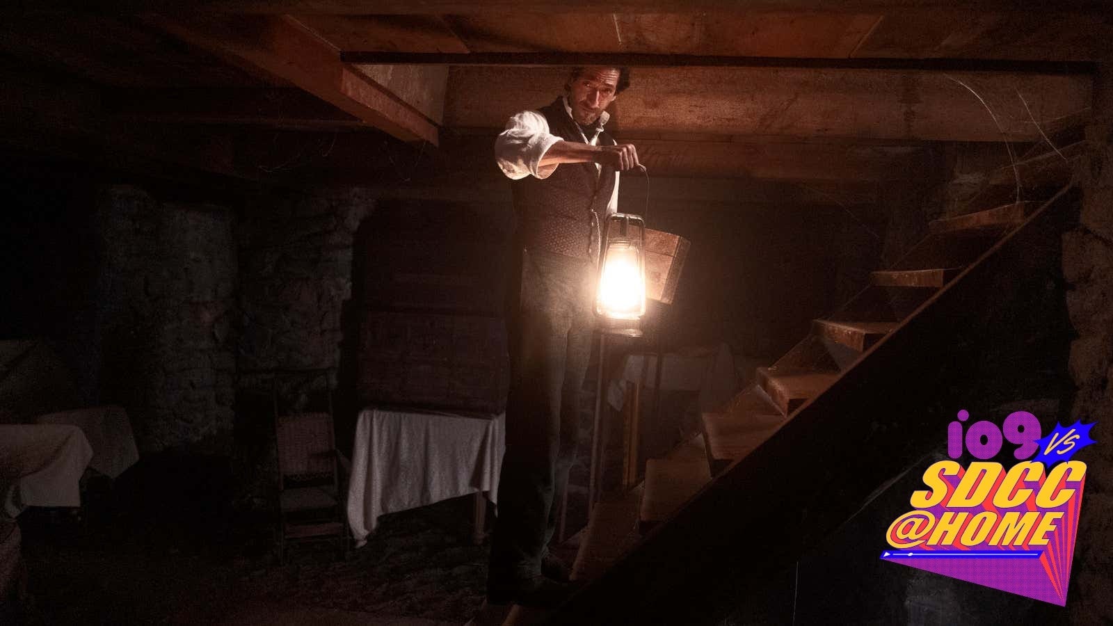 A lantern-toting Captain Charles Boone (Adrien Brody) is surrounded by darkness in Chapelwaite.