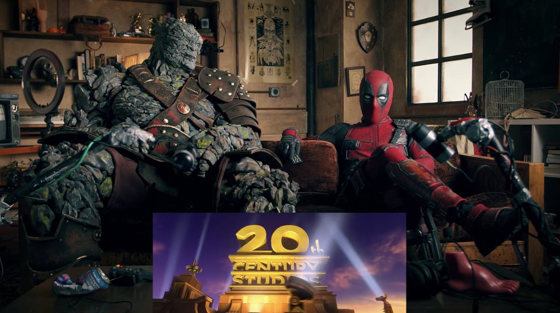 Korg and Deadpool watching a trailer for a movie.