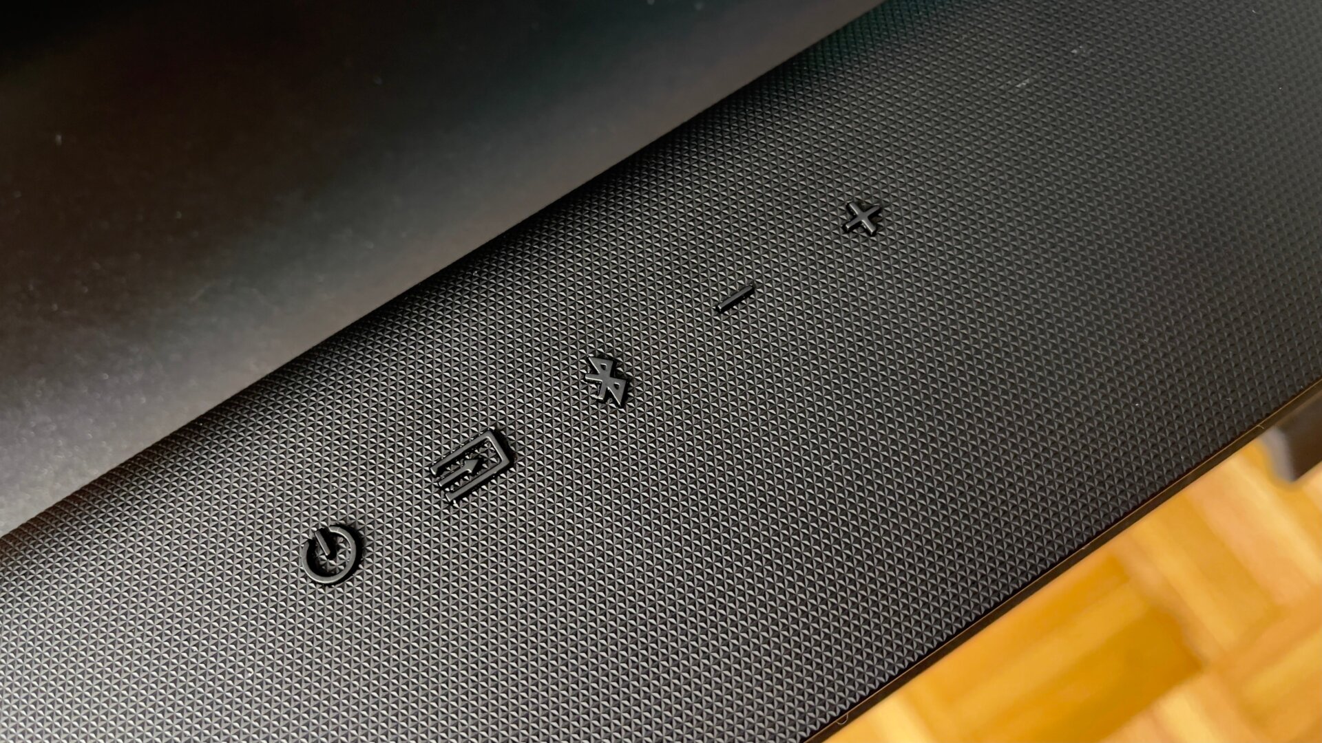 The top of the soundbar features physical controls.