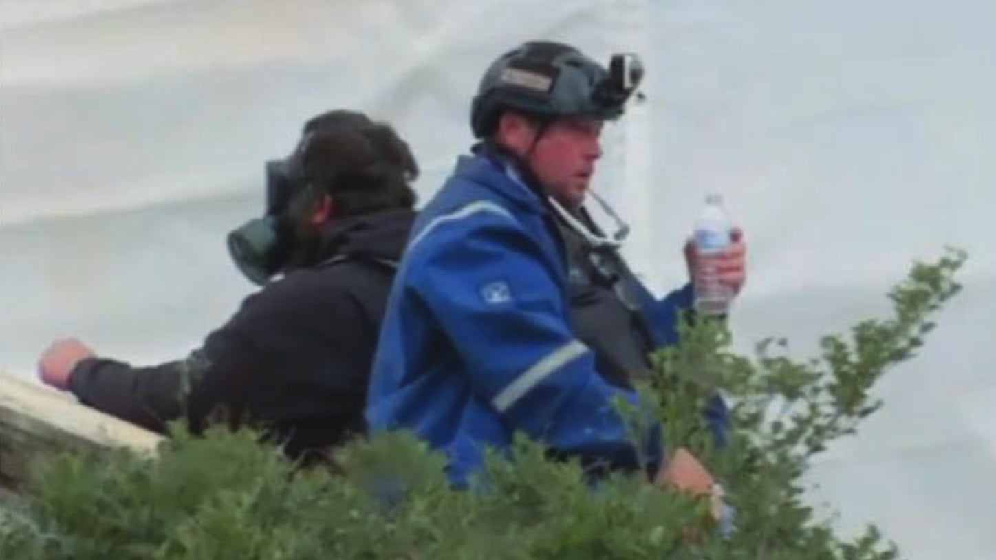 Fox News footage of a man identified by authorities as Guy Reffitt, pictured here outside the Capitol on Jan. 6 using water to flush his eyes of a chemical irritant, and included as evidence in his indictment.