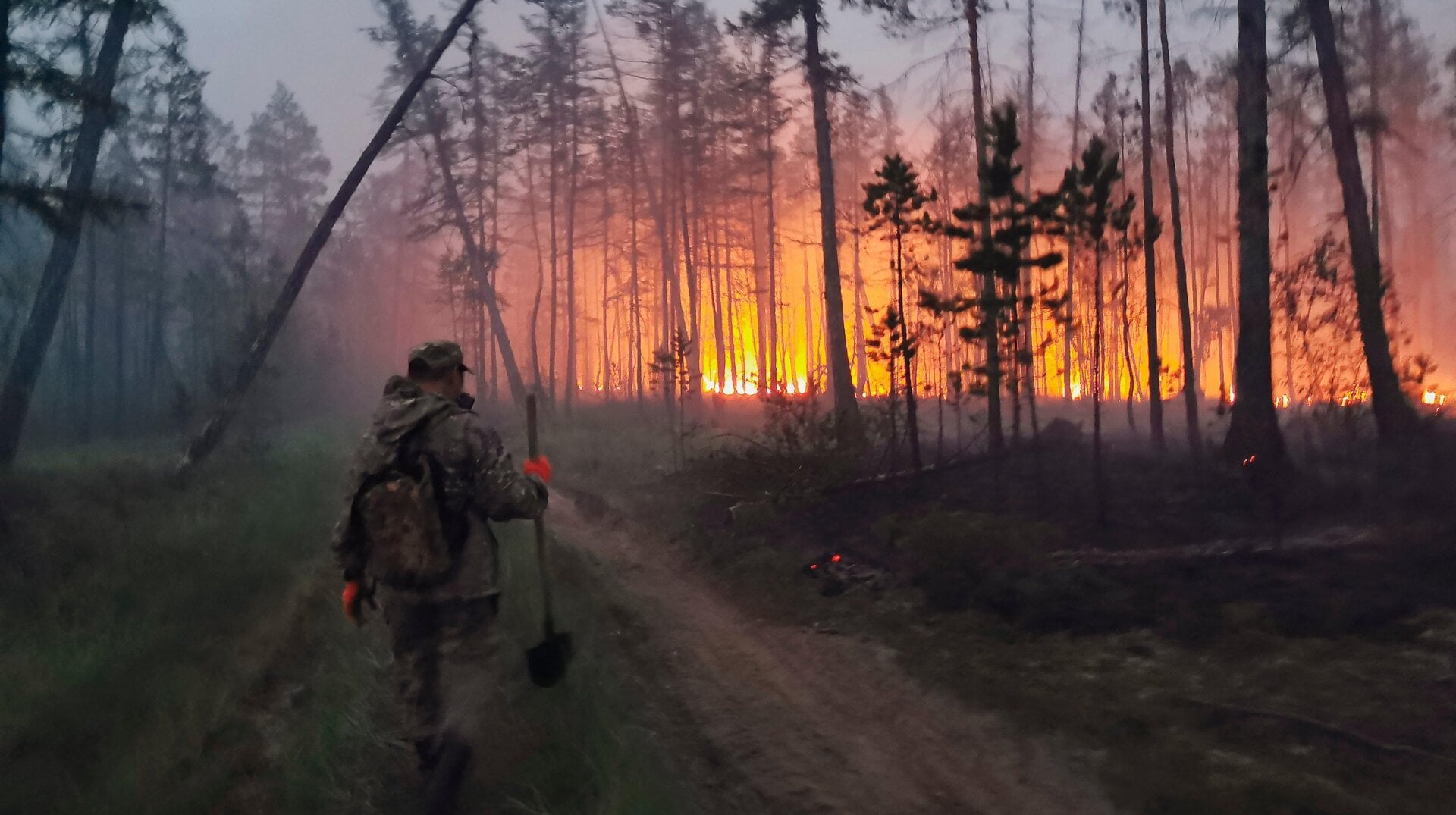 A volunteer heads to douse a forest fire in the republic of Sakha.