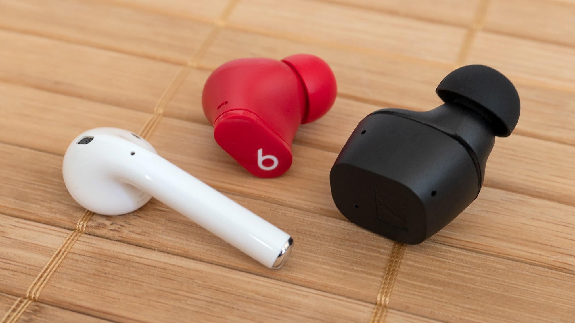 The Sennheiser CX True Wireless (right) aren’t the smallest wireless earbuds you can buy. The Beats Studio Buds (center) are much smaller by comparison, but they’re lightweight and with the right silicon eartips they’ll stay secure in your ears.