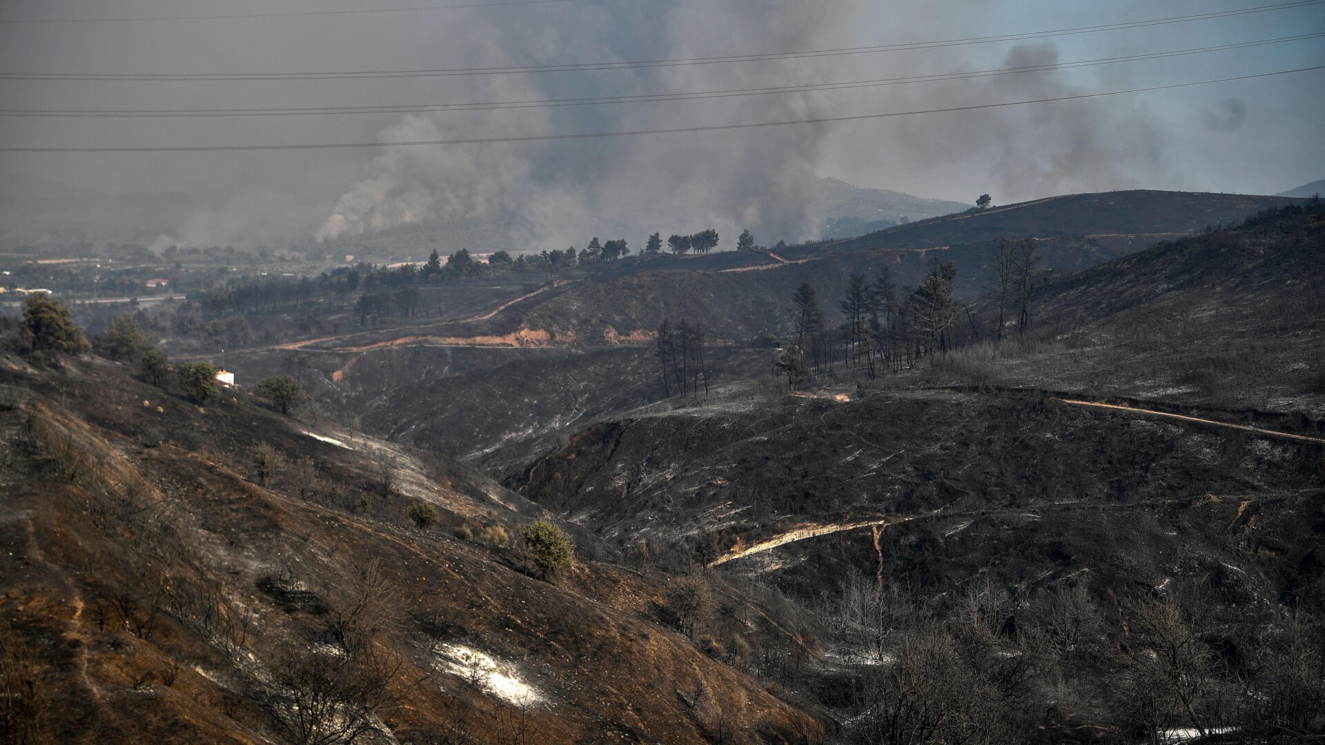 A picture taken on August 6, 2021, shows burnt hills in Drosopigi, a village north of Athens, Greece.