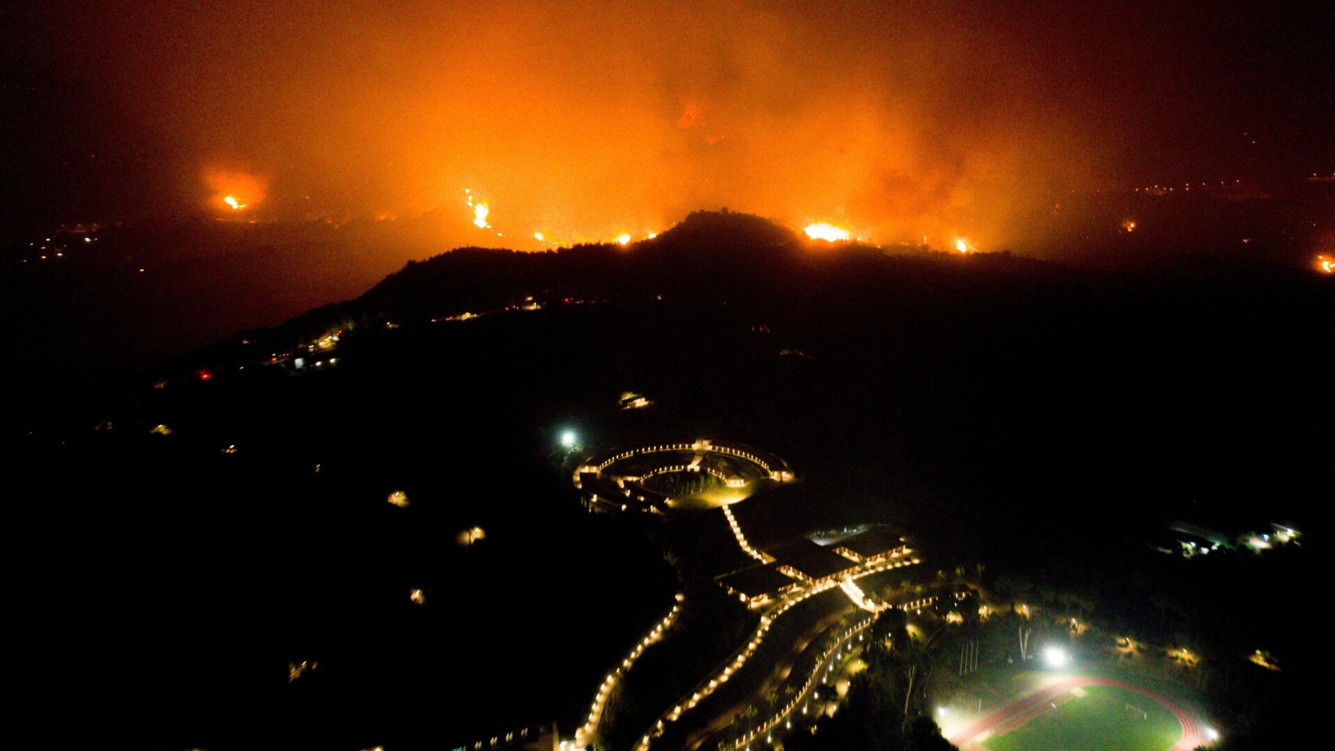 A wildfire approaches the Olympic Academy in western Greece on August 4, 2021. 