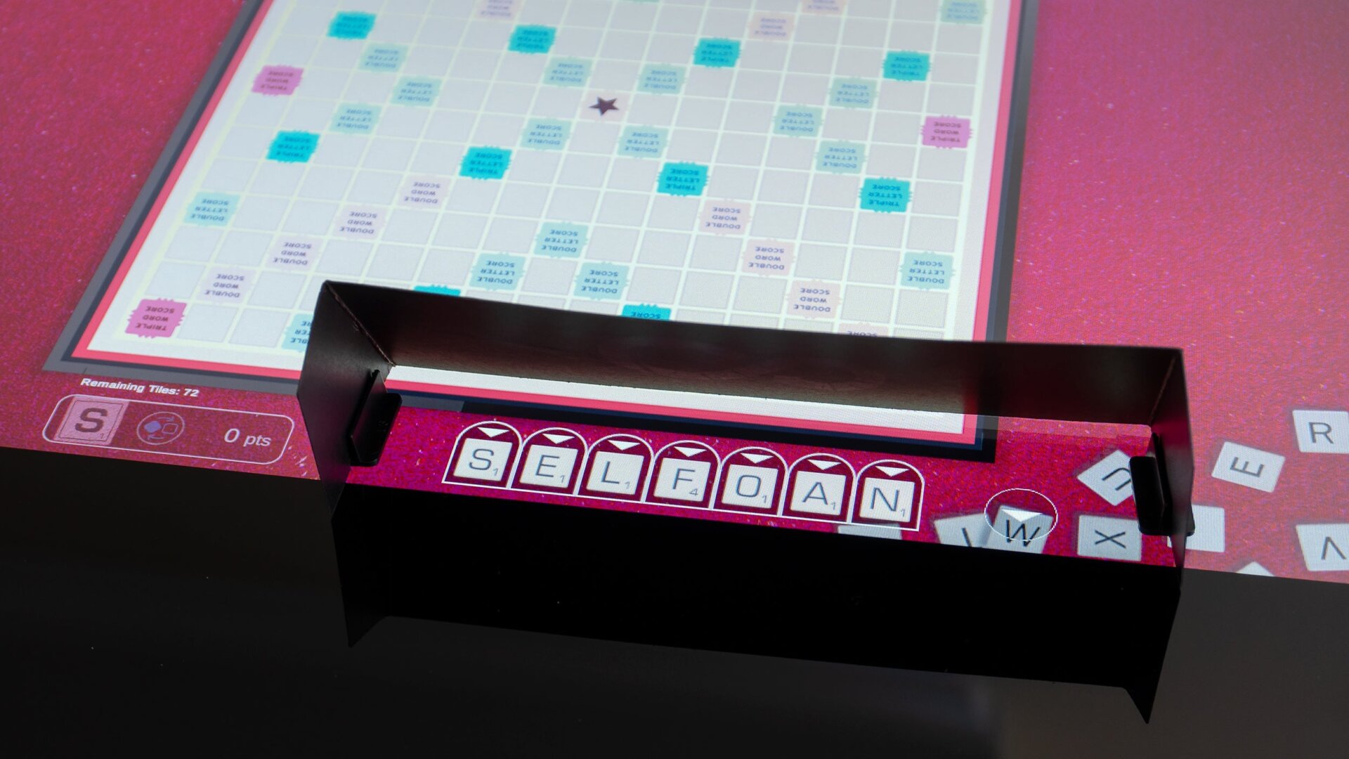 Some games don’t translate to a giant touchscreen as well as others. Scrabble requires players to use a physical shield to keep their letter tiles hidden from other players.