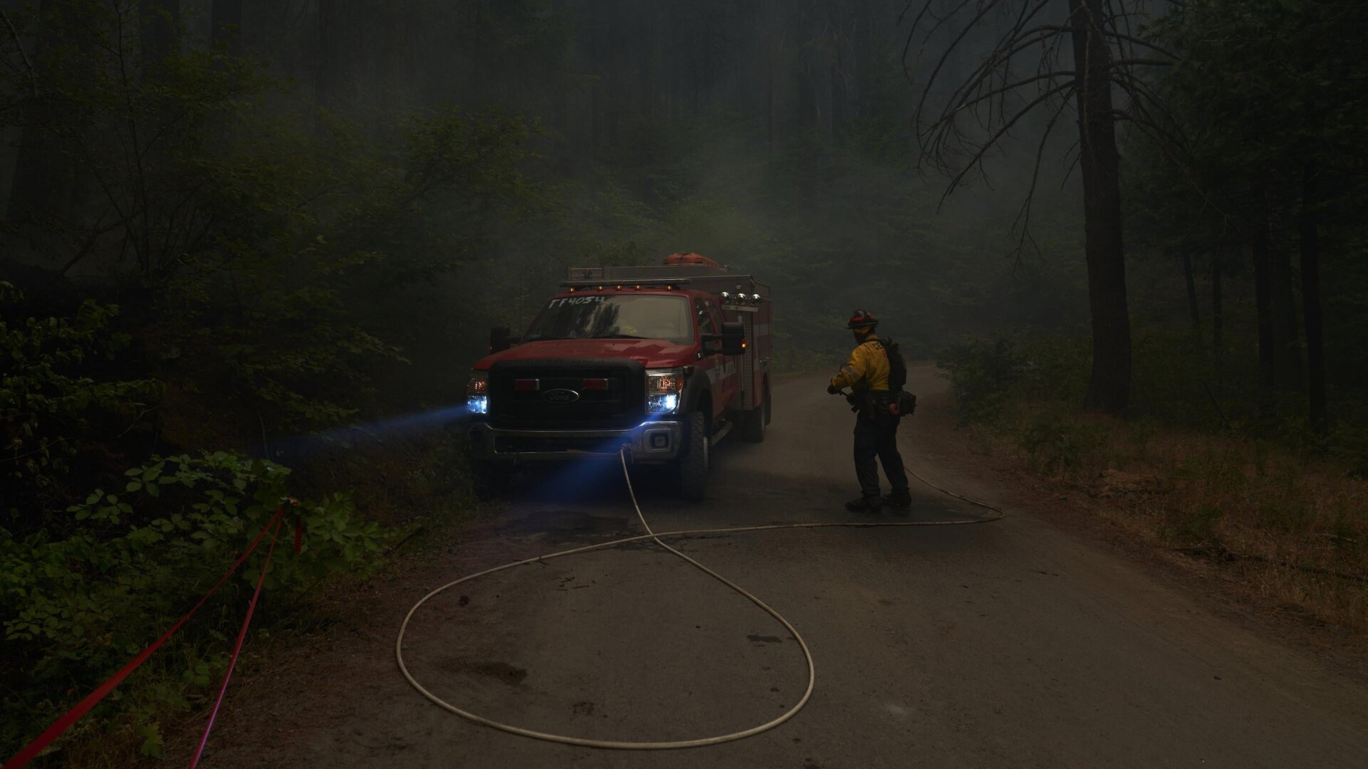 Firefighters battle spot flare-ups from the Caldor Fire in Riverton, California, less than 30 miles from South Lake Tahoe. 