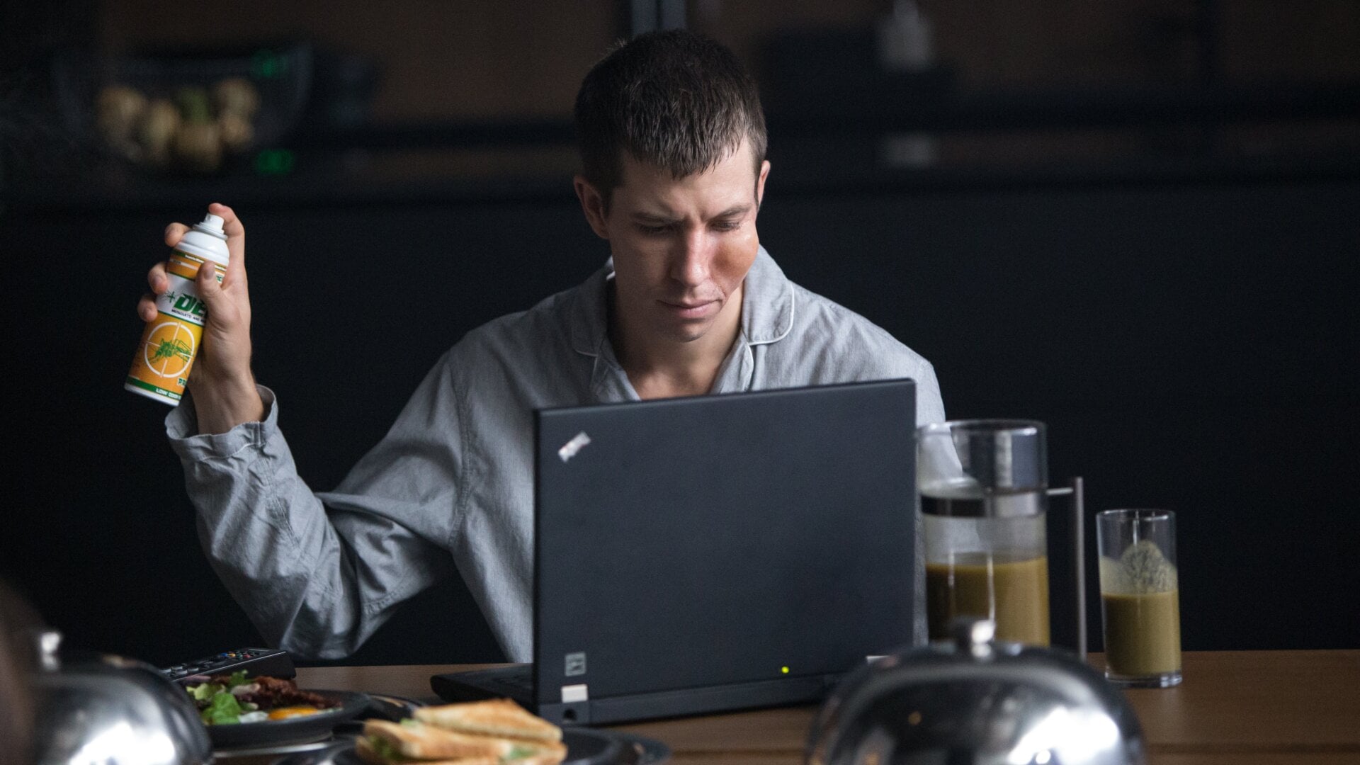 Richard keeps an eye on the news and a hand on the mosquito repellent.