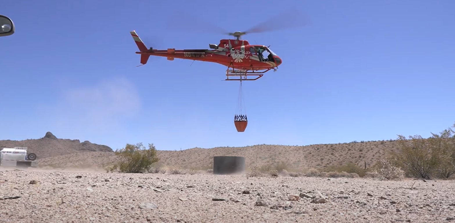 A chopper fills a water catchment.