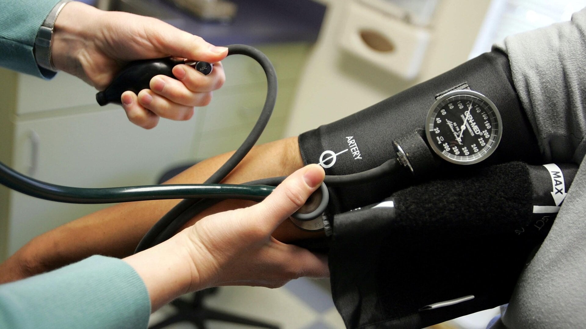 A doctor taking a patient’s blood pressure measurement.