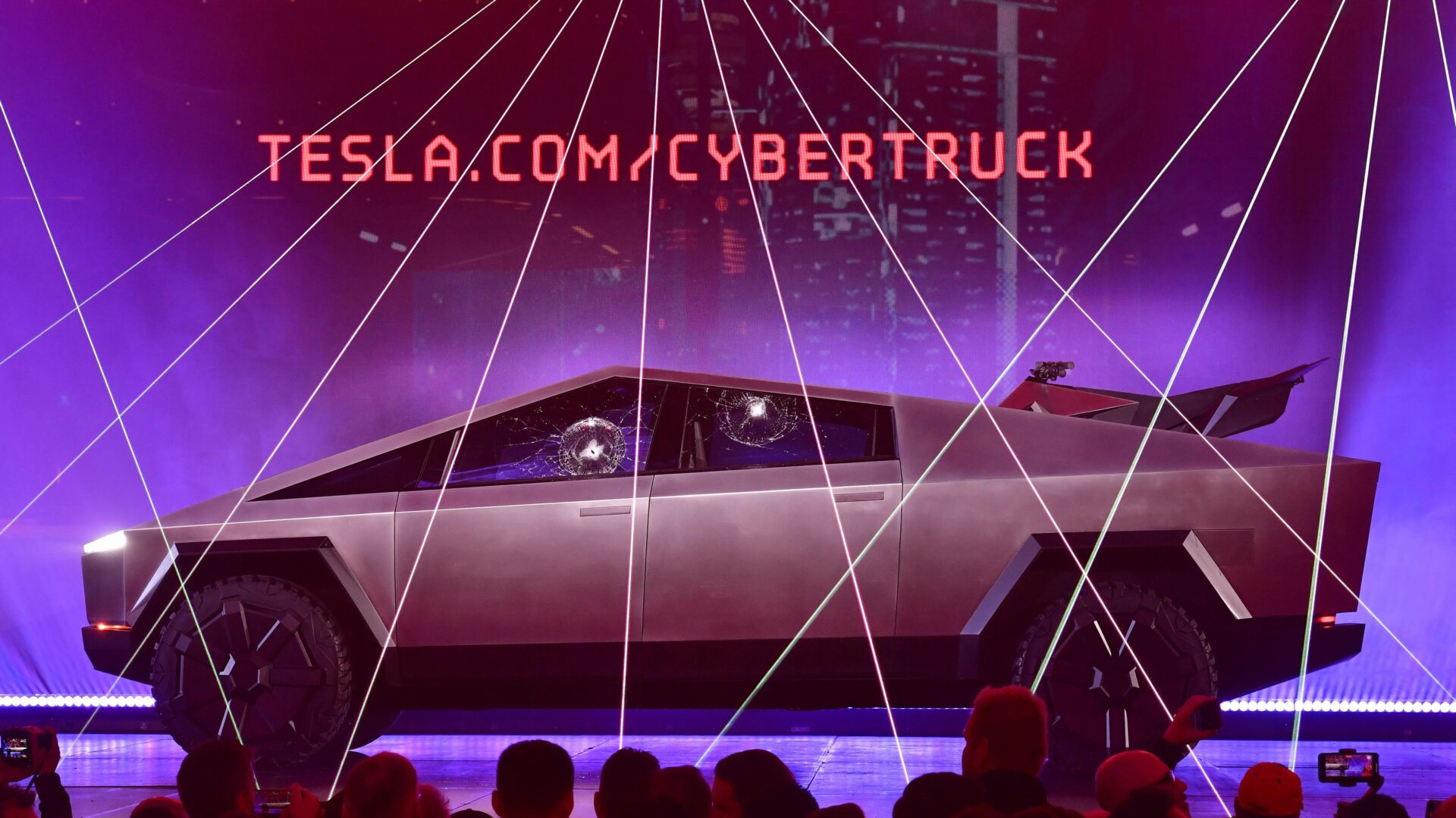 People take pictures of the newly unveiled all-electric battery-powered Tesla’s Cybertruck with shattered windows after a failed resistance test on November 21, 2019.