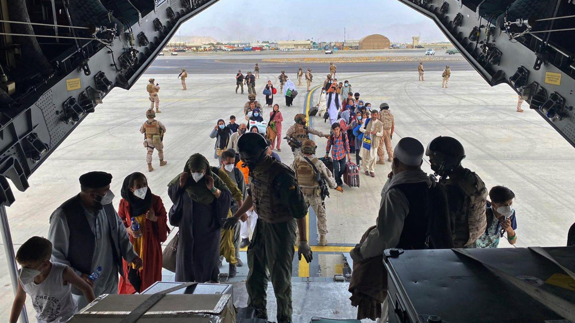People board a Spanish airforce A400 plane as part of an evacuation plan at Kabul airport in Afghanistan, Wednesday Aug. 18, 2021.