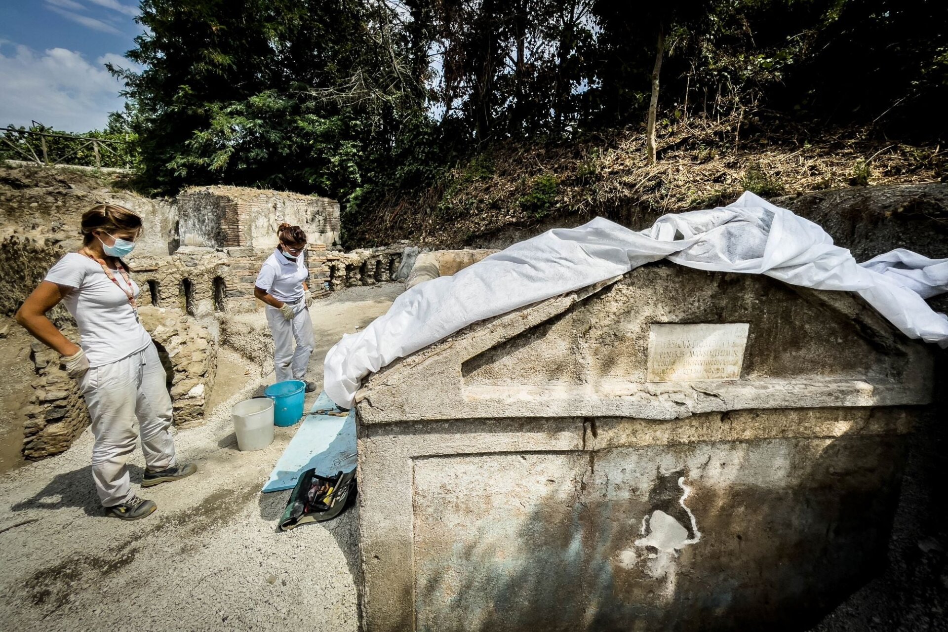 Team members inspecting the tomb. 
