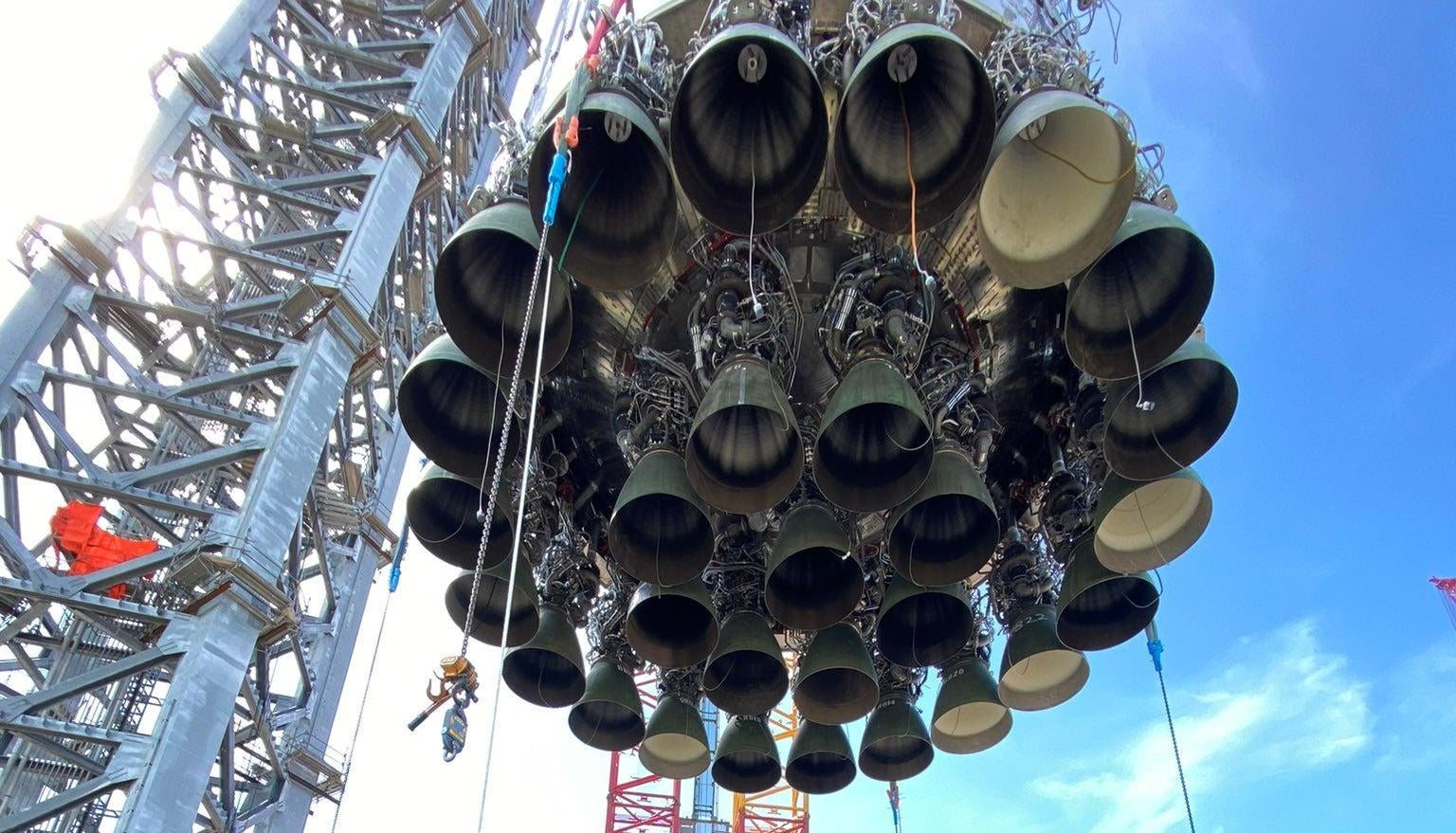 The Super Heavy booster—and its 29 Raptor engines—being lowered to the orbital launch pad.