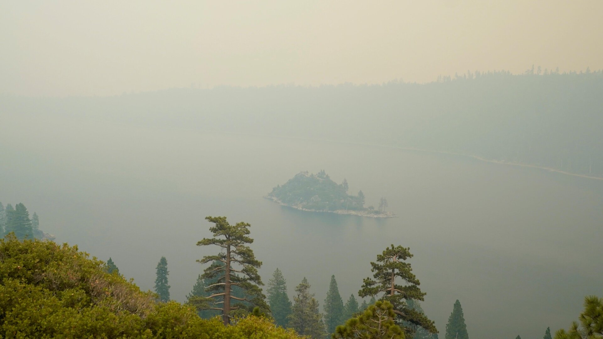 Lake Tahoe’s iconic Emerald Bay is shrouded in smoke from the Caldor Fire.