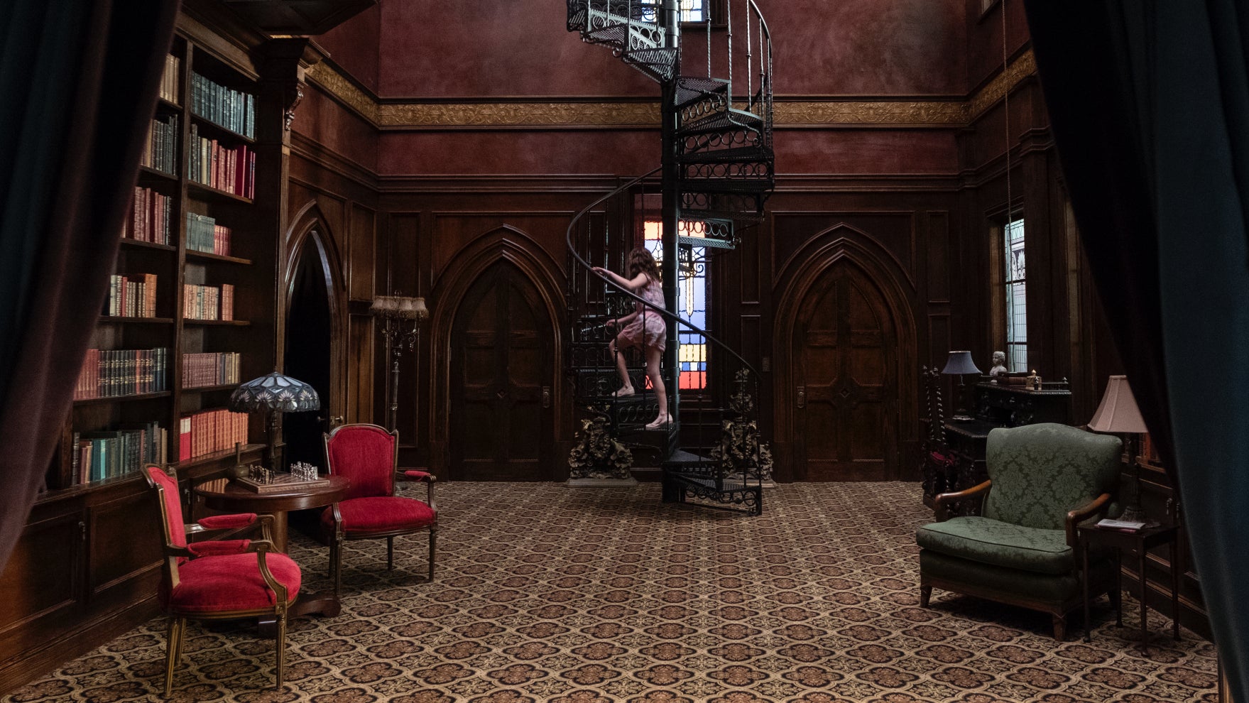 Young Shirley (Lulu Wilson) climbs some spooky stairs in The Haunting of Hill House.