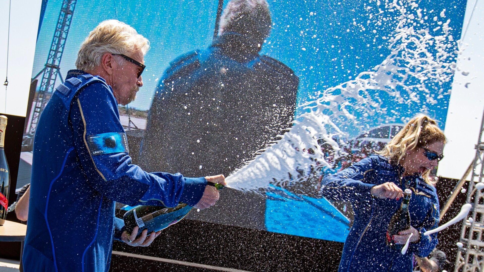 Virgin Galactic founder Richard Branson spraying champagne onto crew member Beth Moses after their flight to space.