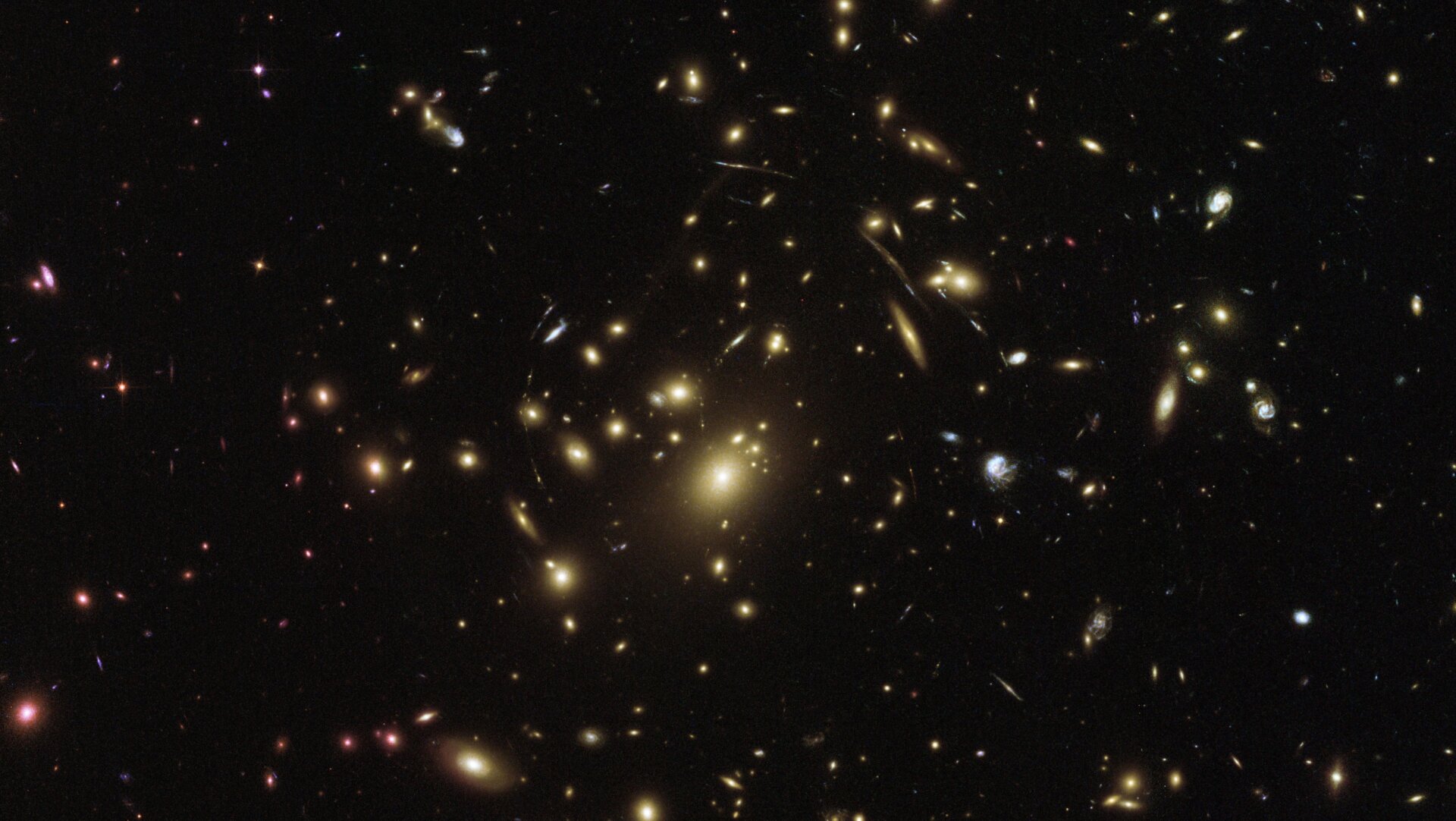 The massive galaxy cluster Abell 2357, which bends spacetime around it with its massive gravity (which you can see if you squint) in an image taken by Hubble.