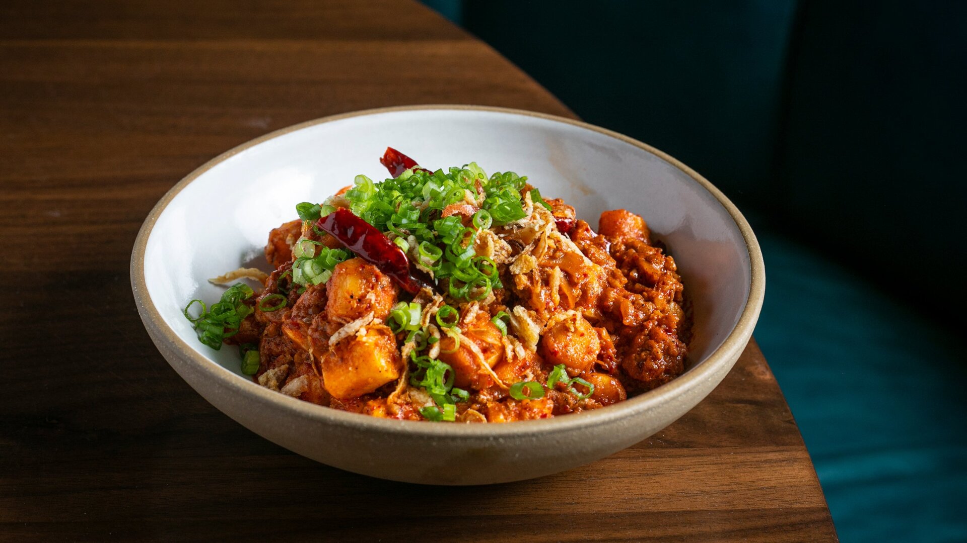 Momofuku Ssäm Bar’s new Impossible Pork Ragu on top of its Spicy Rice Cakes.