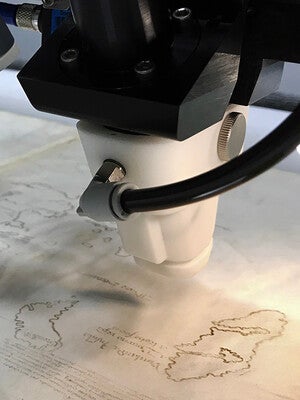 A scanning x-ray fluorescence spectrometer reveals the distribution of elements.