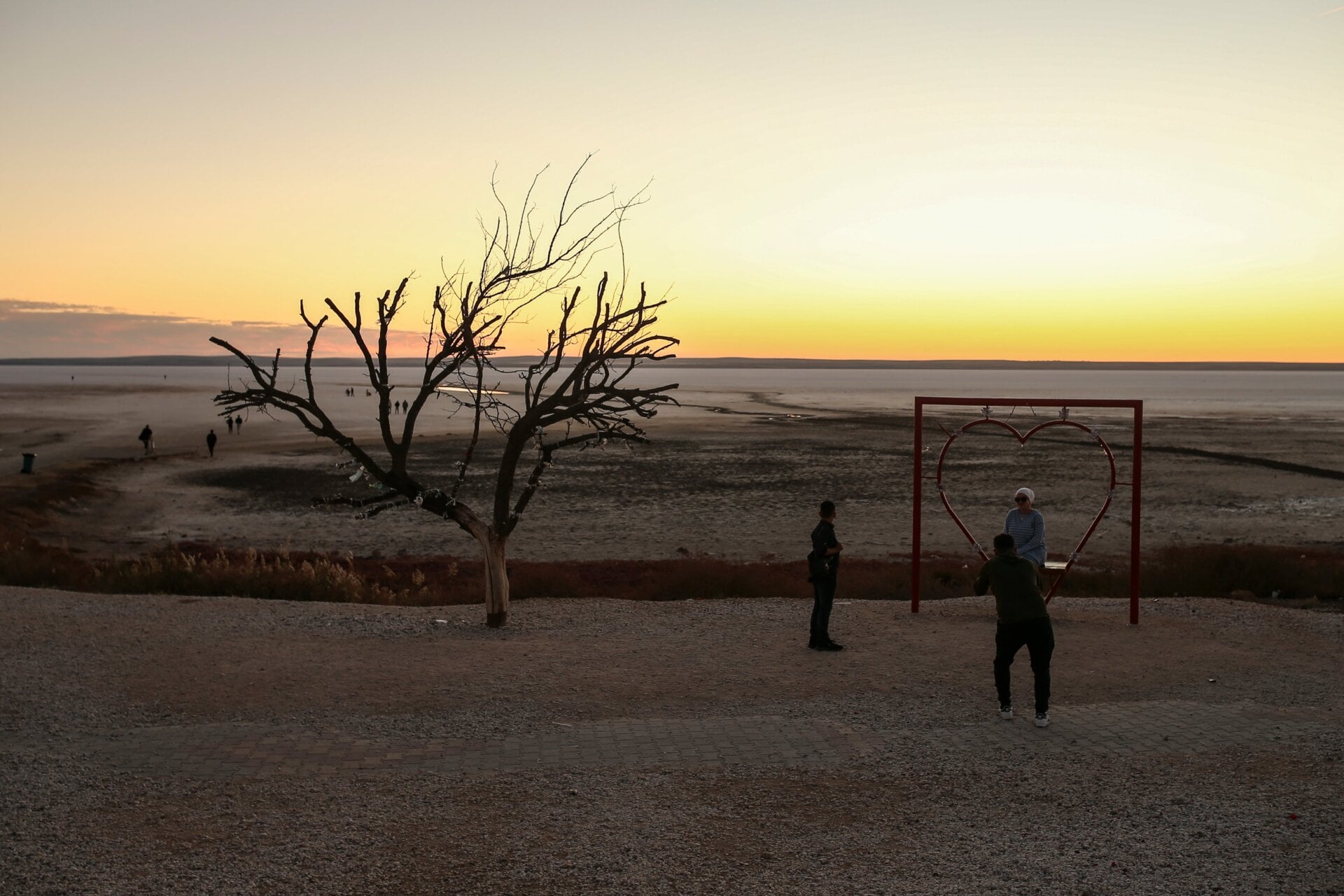 People take photographs at Tuz lake in Ankara, Tuesday, Oct. 26, 2021.