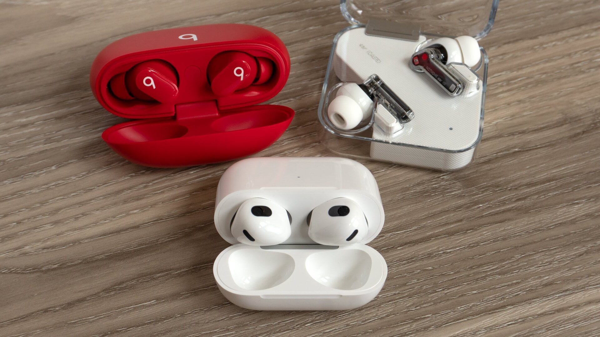 The third-gen AirPods (bottom) with the Beats Studio Buds (top left) and the Nothing Ear (1) (top right).