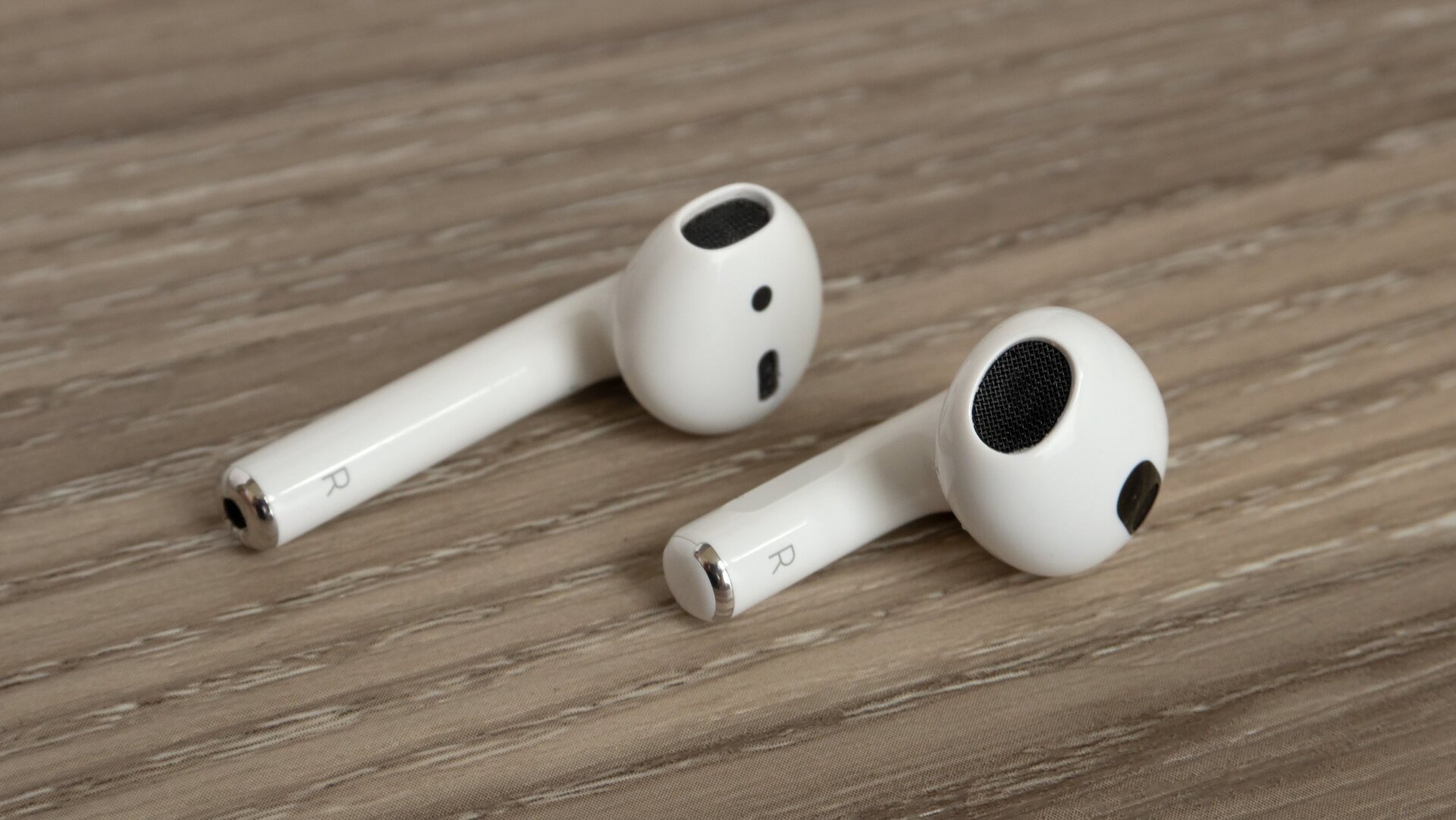 The new AirPods (right) have a more contoured design that also sits in the ear at a better angle than the second-gen AirPods (left) do.