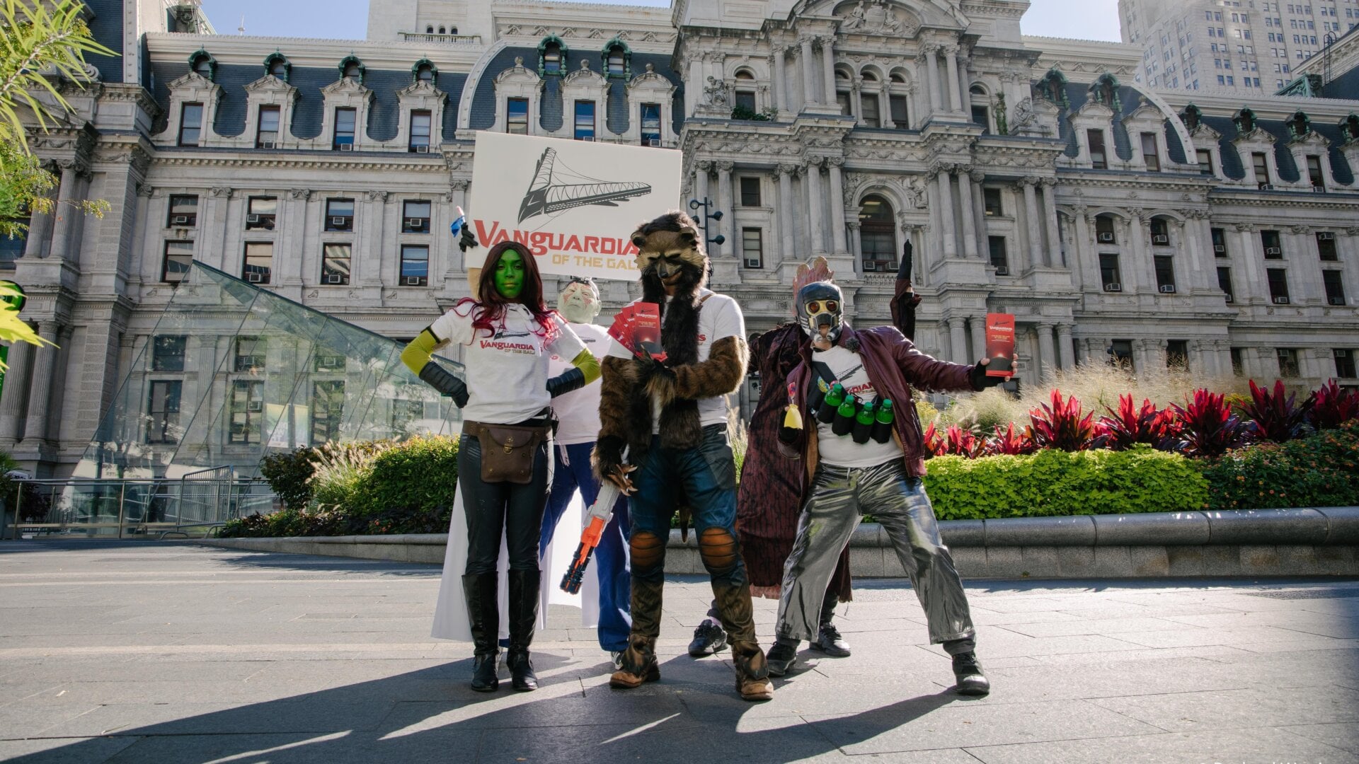 Activists dressed as “Vanguardians” give out fake brochures in front of Vanguard’s headquarters Wednesday.