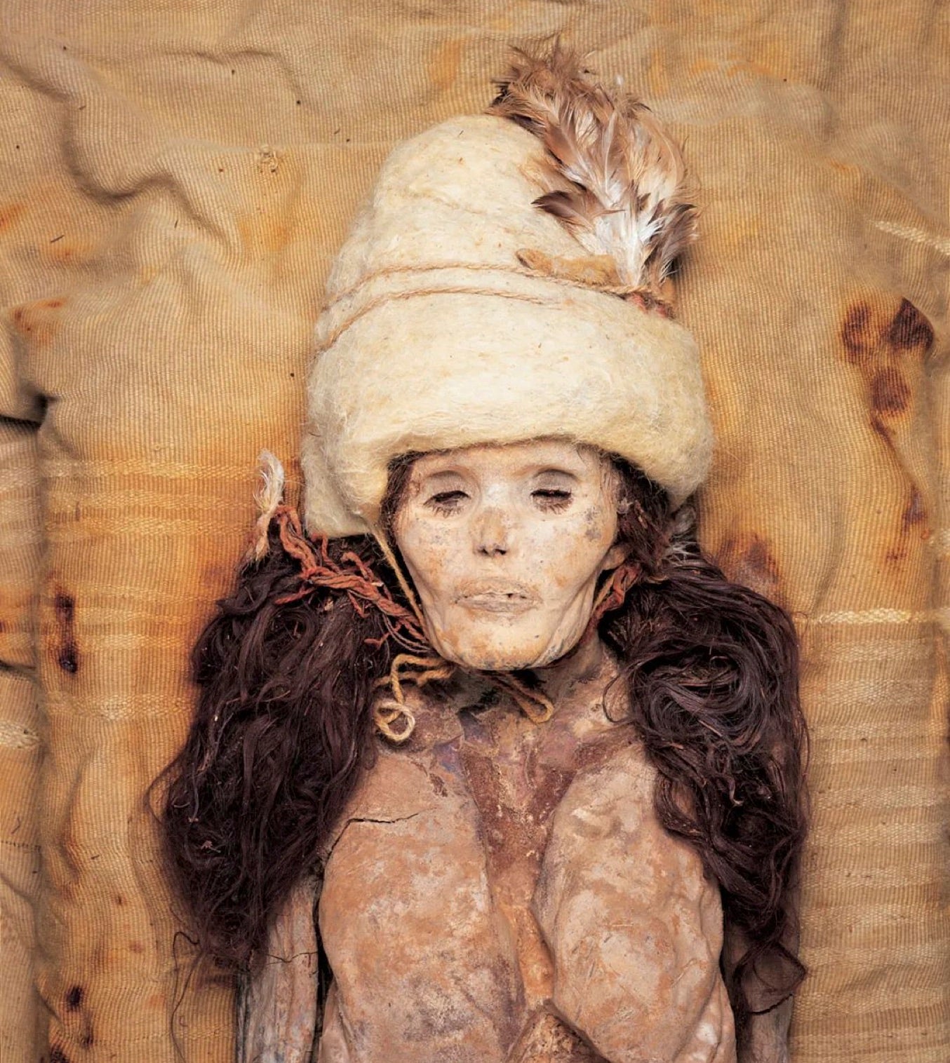 A Tarim Basin woman mummified in Xiaohe, still with her hair and hat from life.