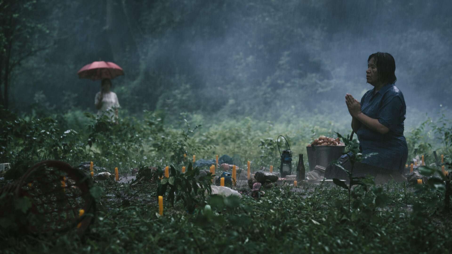 Nim prays as Noi watches,