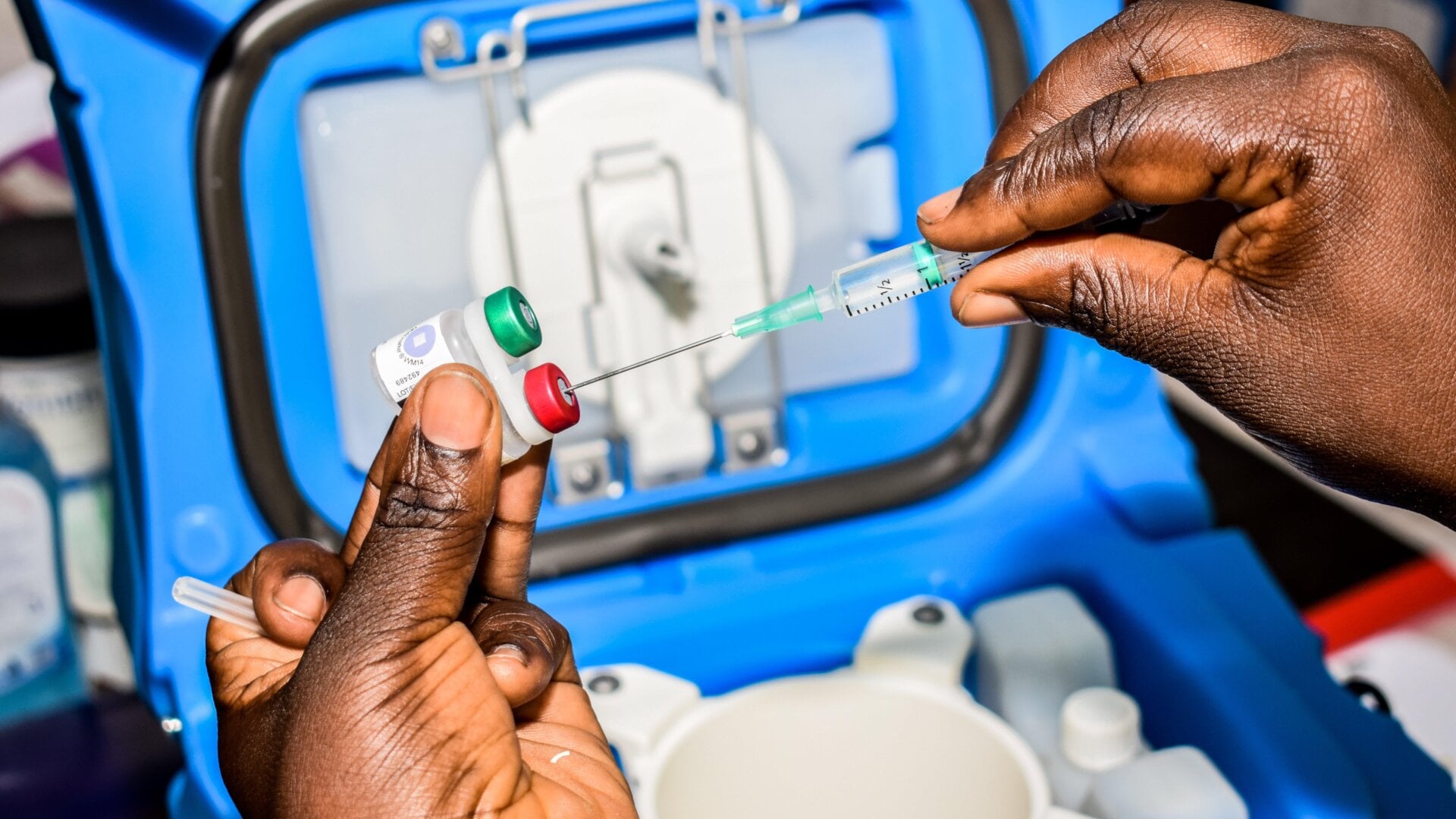 A health worker prepares a dose of the Mosquirix malaria vaccine in Ndhiwa, Homabay County, western Kenya on September 13, 2019.
