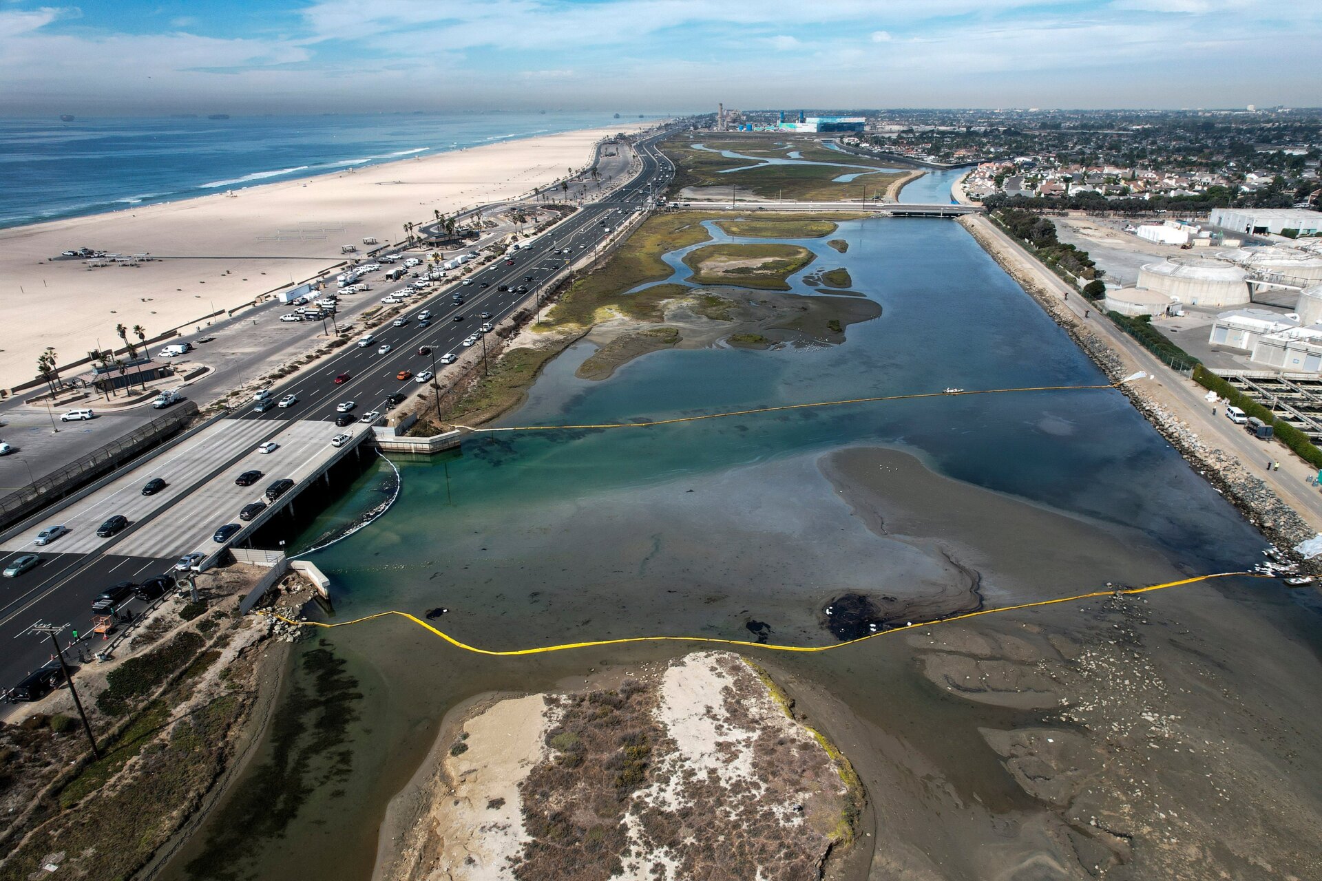 Floating barriers known as booms are set up to try to stop further oil incursion into the Talbert Marsh.