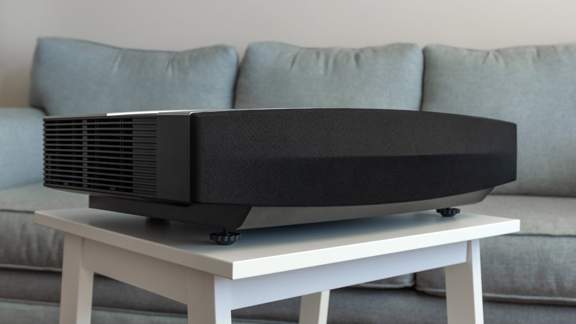 Hidden behind a fabric screen are 60 watts of speakers that easily fill a room with audio, but there’s no surround sound effect.