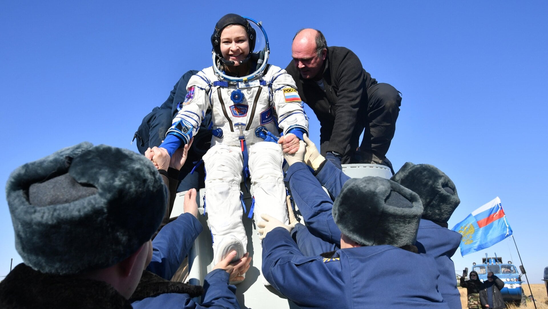 Russian space agency rescue team members help actress Yulia Peresild out from the capsule shortly after the landing of the Russian Soyuz MS-18 space capsule.