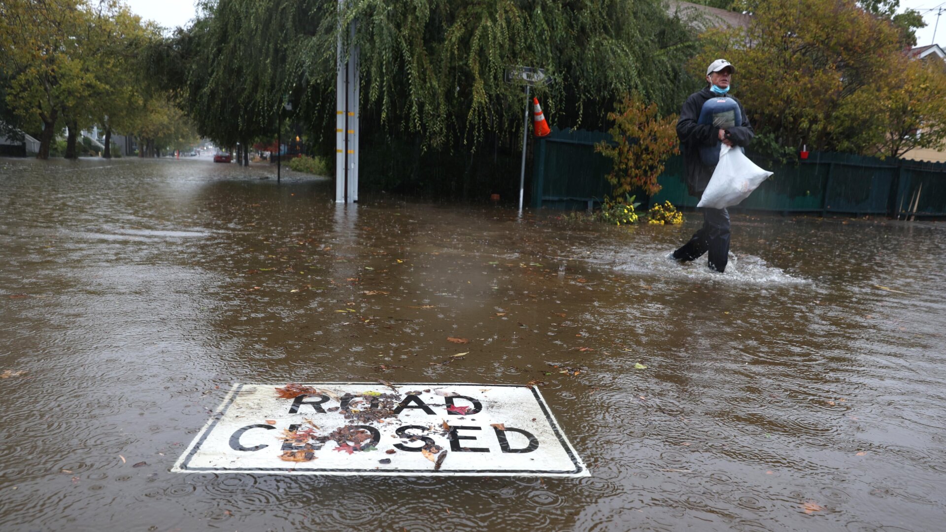 A “road closed” sign floats on a flooded street on October 24, 2021 in San Rafael, California.