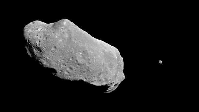 The asteroid Ida (left) and its diminutive moon, Dactyl (right), imaged by the Galileo spacecraft in 1993.