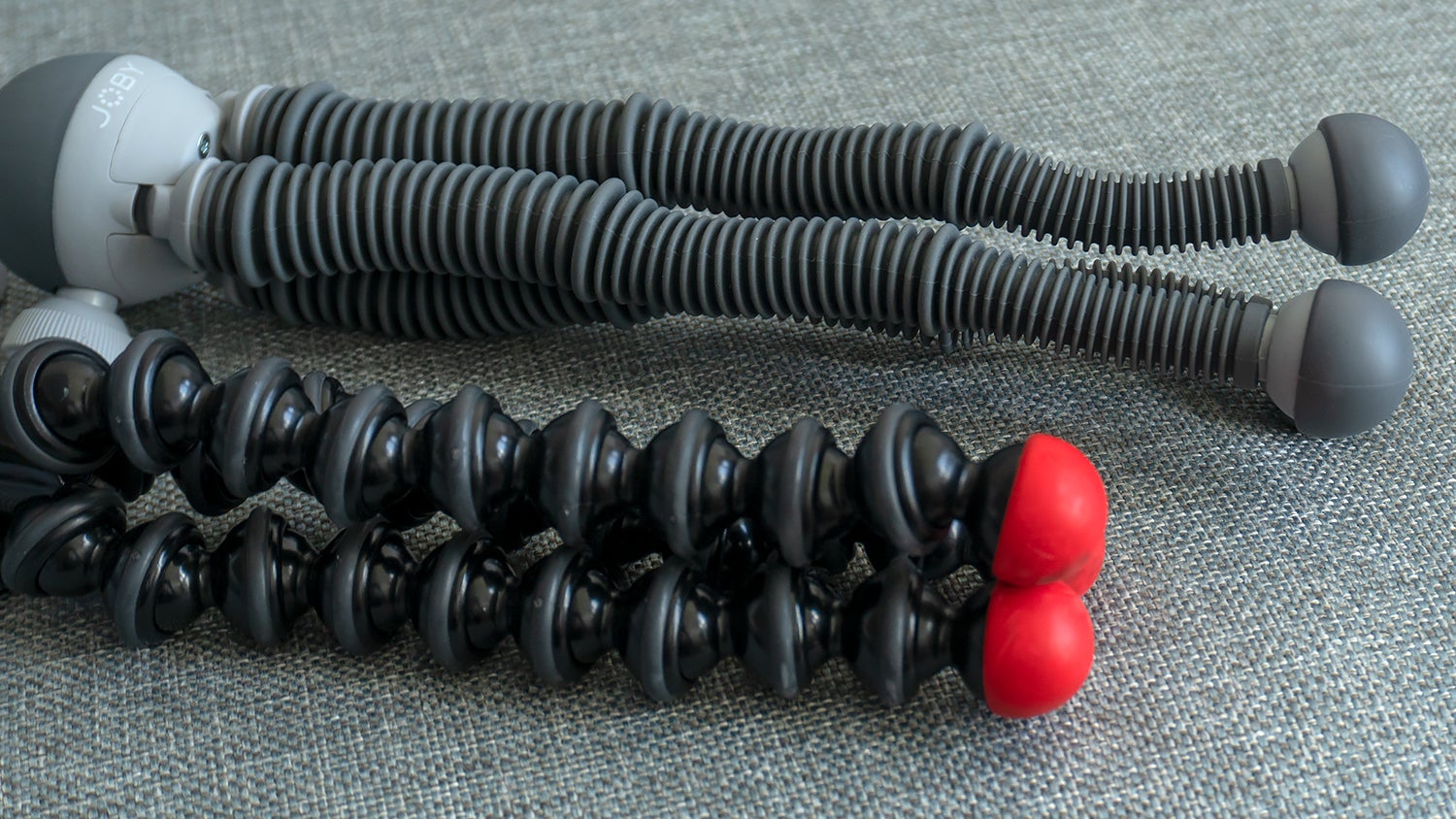 The legs of a GorillaPod tripod (bottom) compared to the redesigned legs on the PodZilla tripod (top).