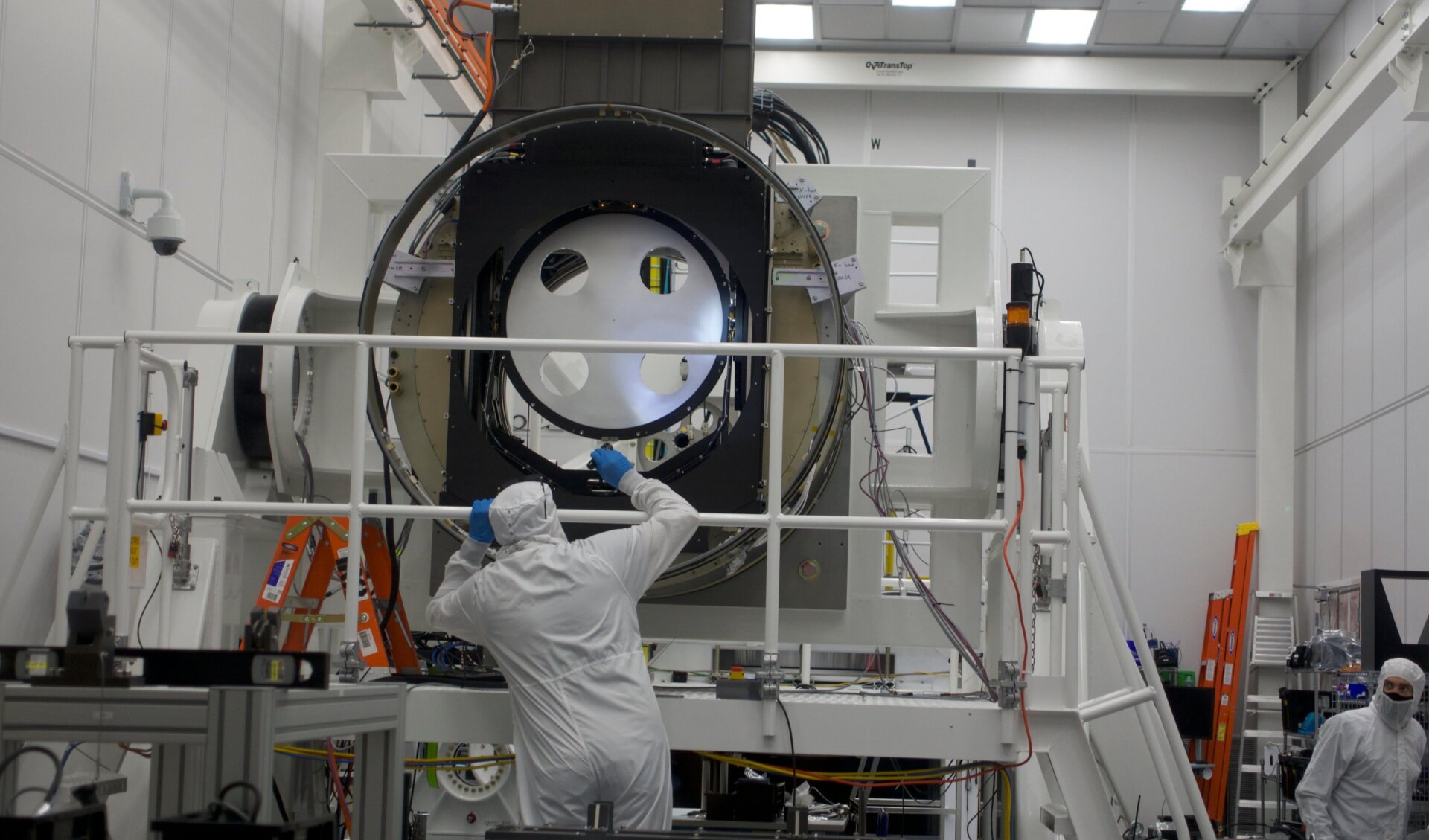 A worker inspects the camera’s filter-changing apparatus, which will allow the camera to capture specific wavelengths.