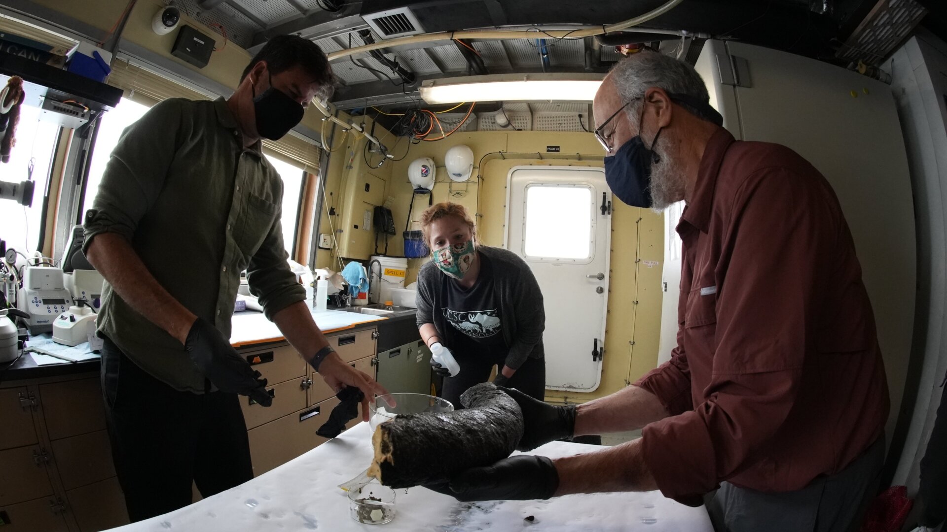 Haddock (left), UC Santa Cruz postdoctoral researcher Katie Moon (center), and University of Michigan paleontologist Daniel Fisher (right) inspecting the oversized tusk in the ship’s lab.